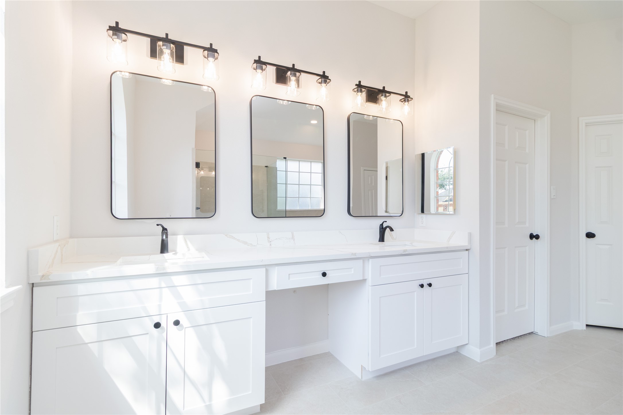 The primary bath was completely updated with new shower glass, tile, fixtures, cabinets, quartz tops, mirrors, and more.