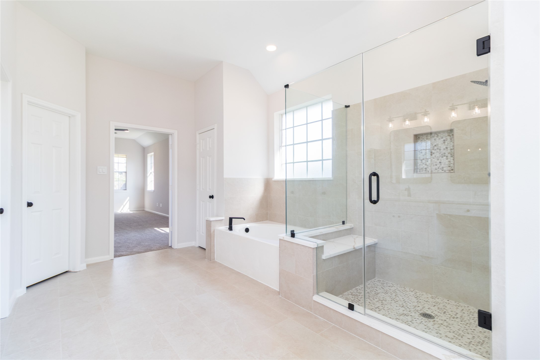 The primary bath was completely updated with new shower glass, tile, fixtures, cabinets, quartz tops, mirrors, and more.