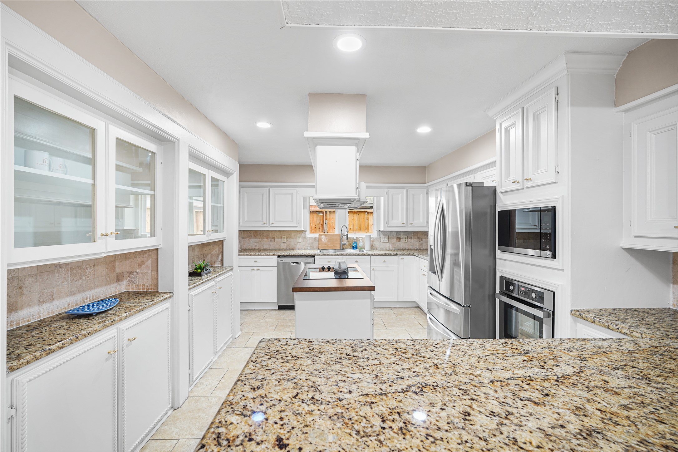 Spacious kitchen with sleek granite countertops, stainless steel appliances, and ample cabinetry for storage.