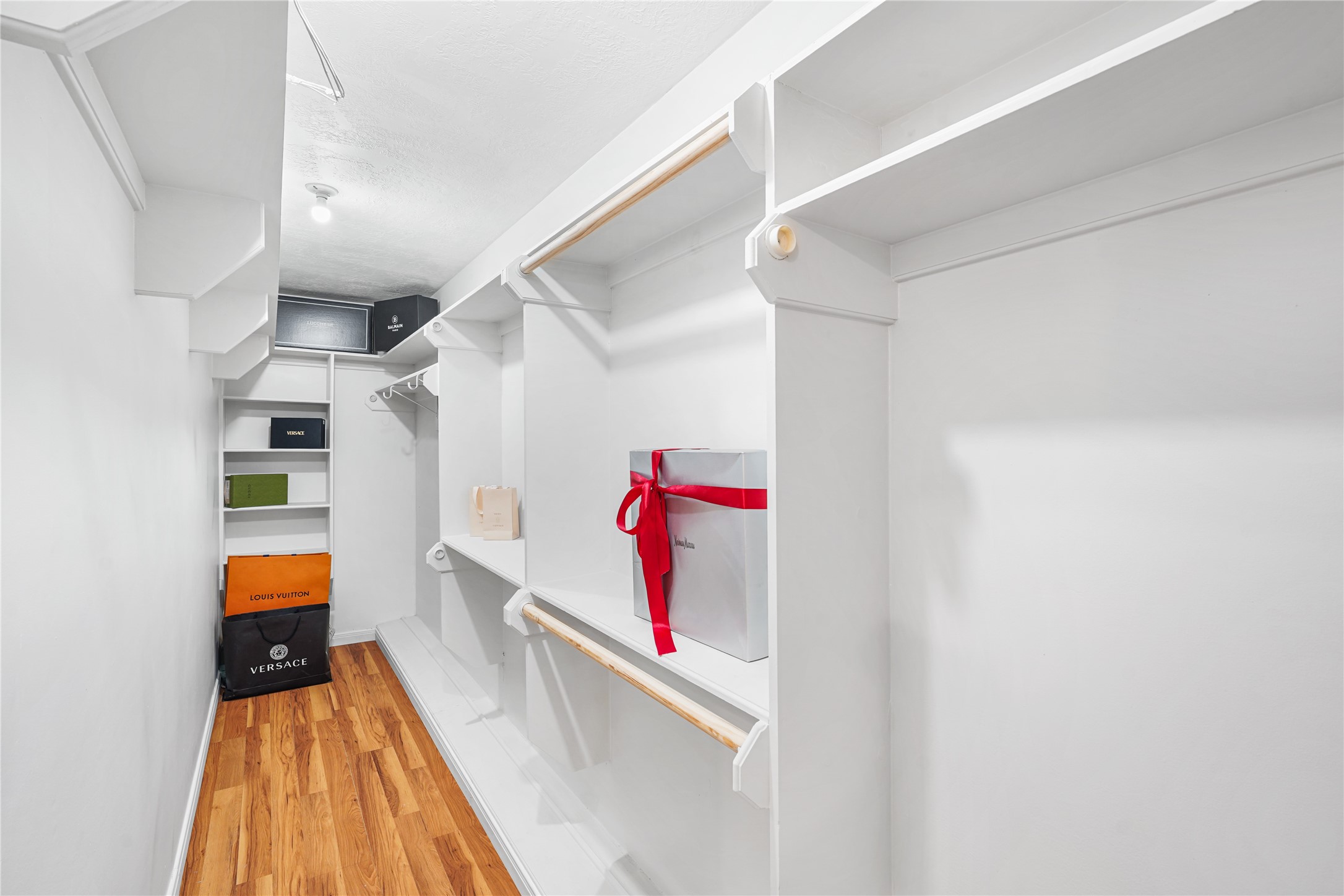 Spacious walk-in closet featuring ample shelving and hanging space, perfect for organizing your wardrobe.