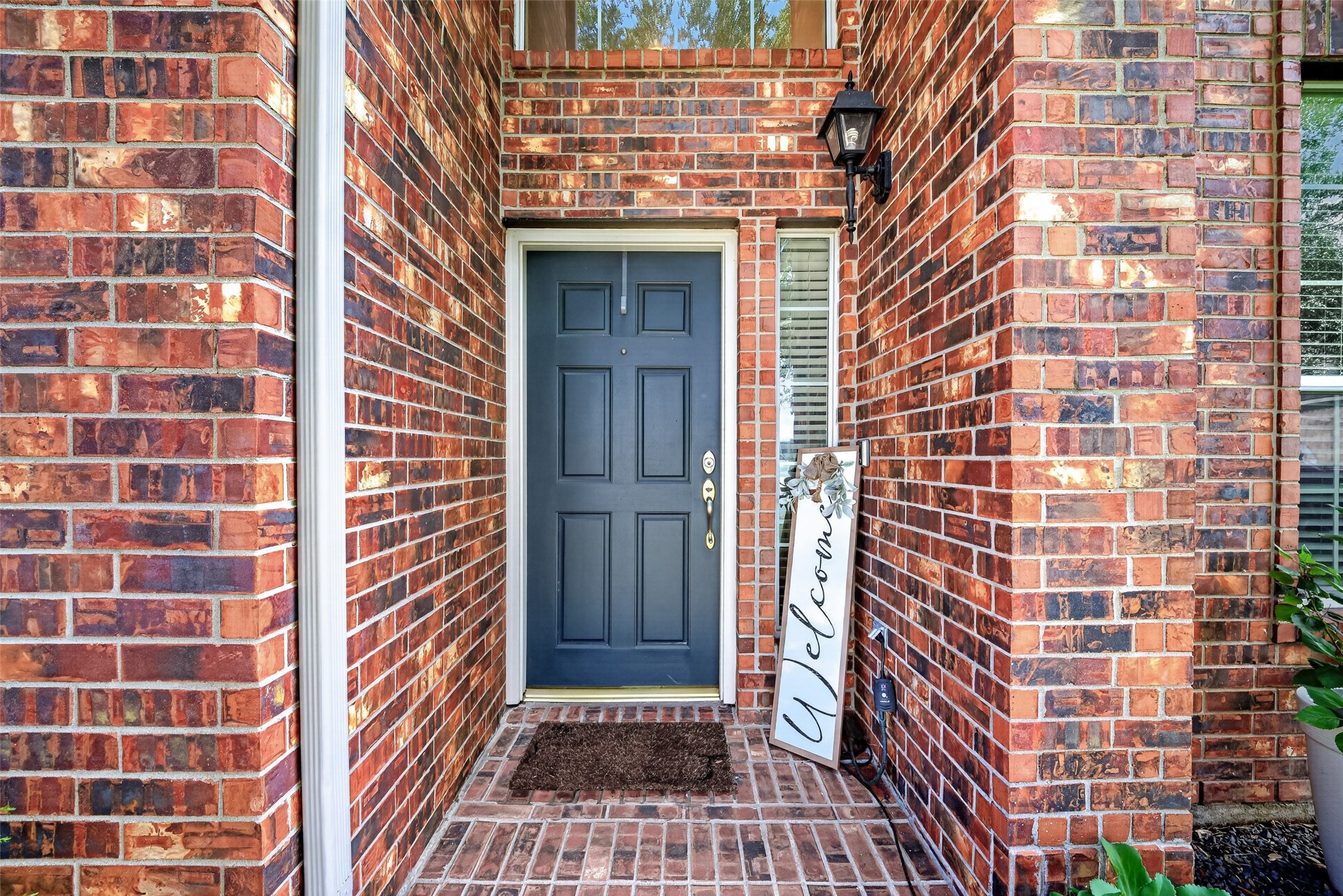 Arched brick entry porch with a welcoming front door. Arched brick entry porch with a welcoming front door.