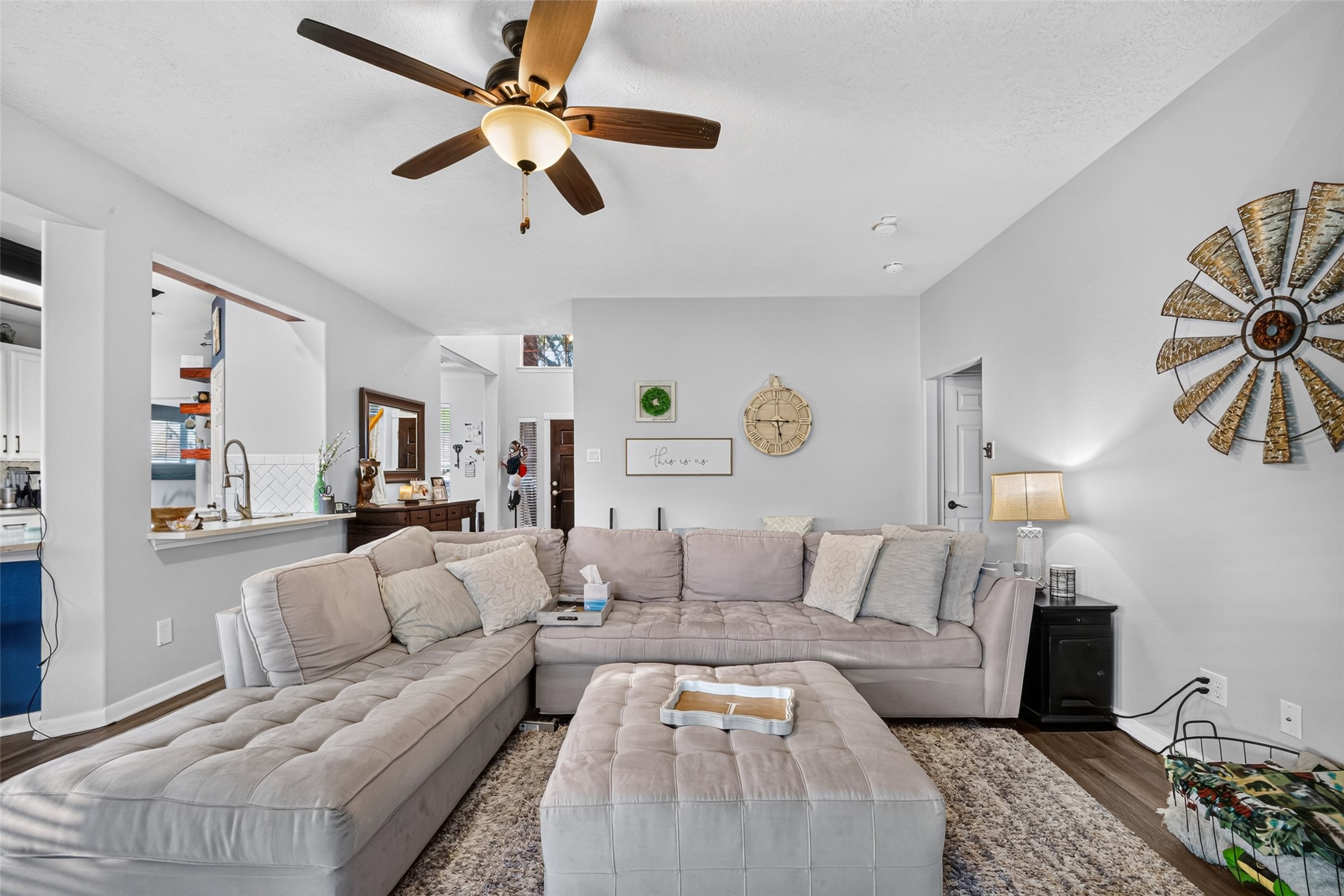 Airy living room flowing seamlessly toward the kitchen.