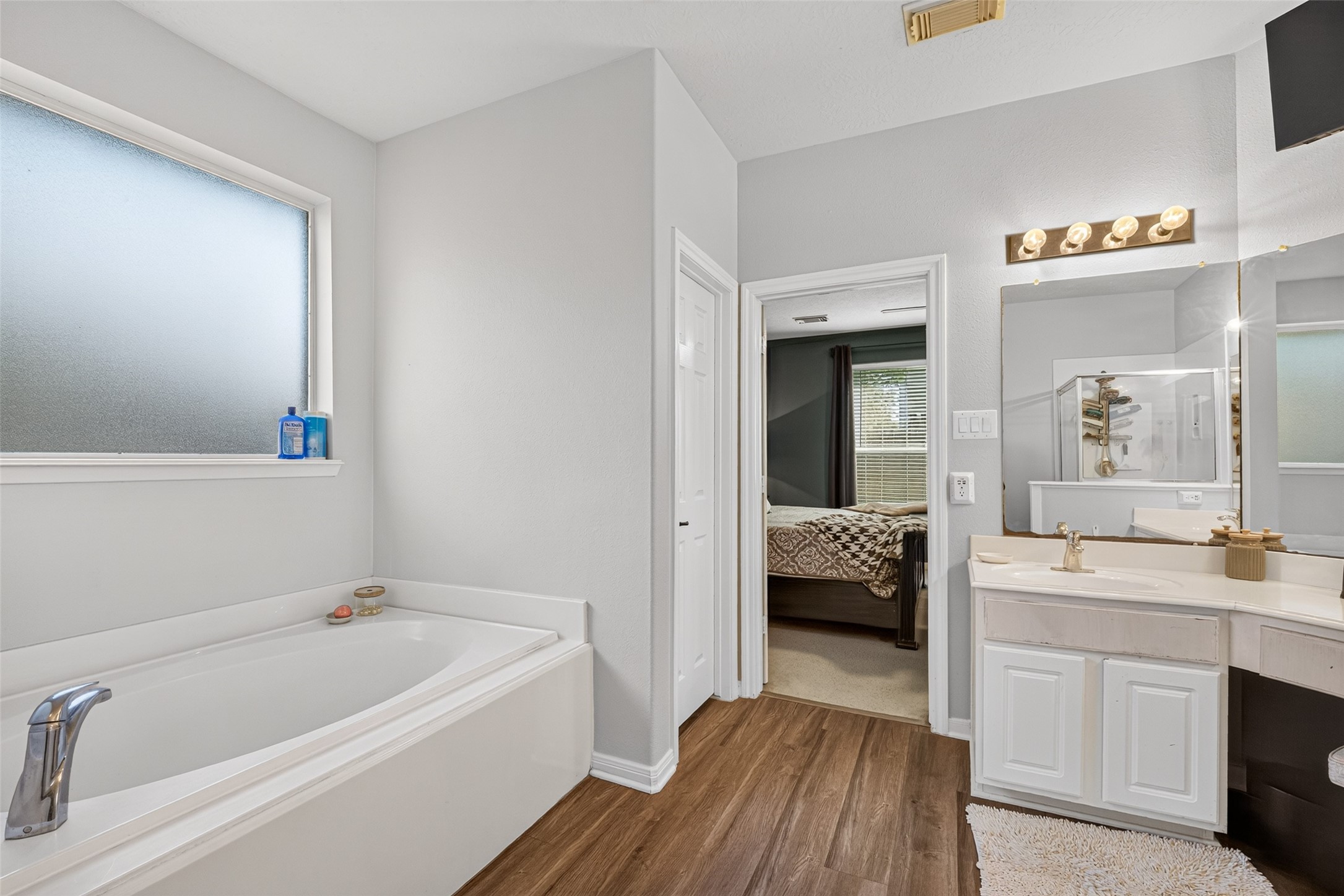 Garden tub and vanity in the calming primary bath.