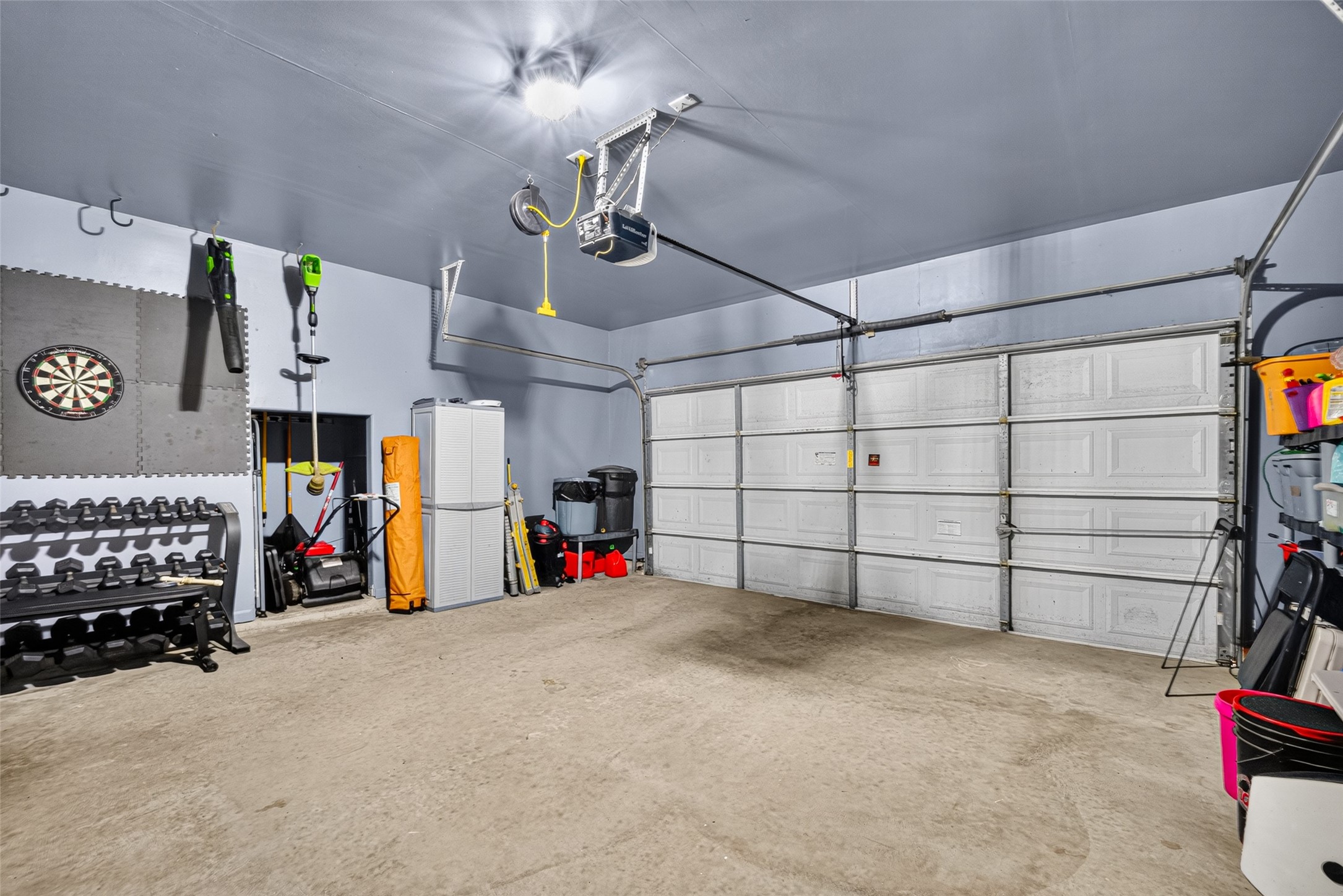 Clean two-car garage with overhead storage.