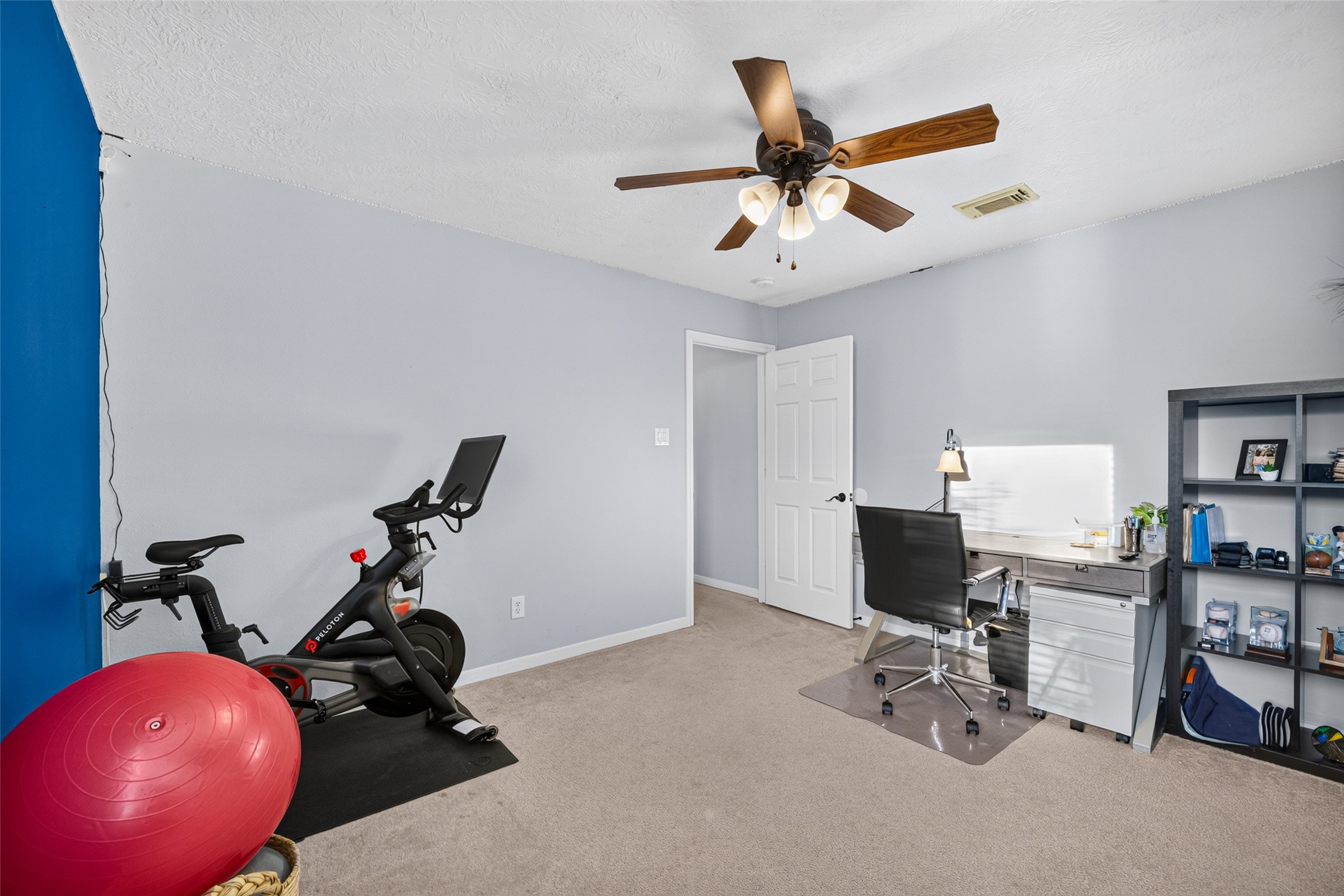 Flex room with space for a home gym or office setup.