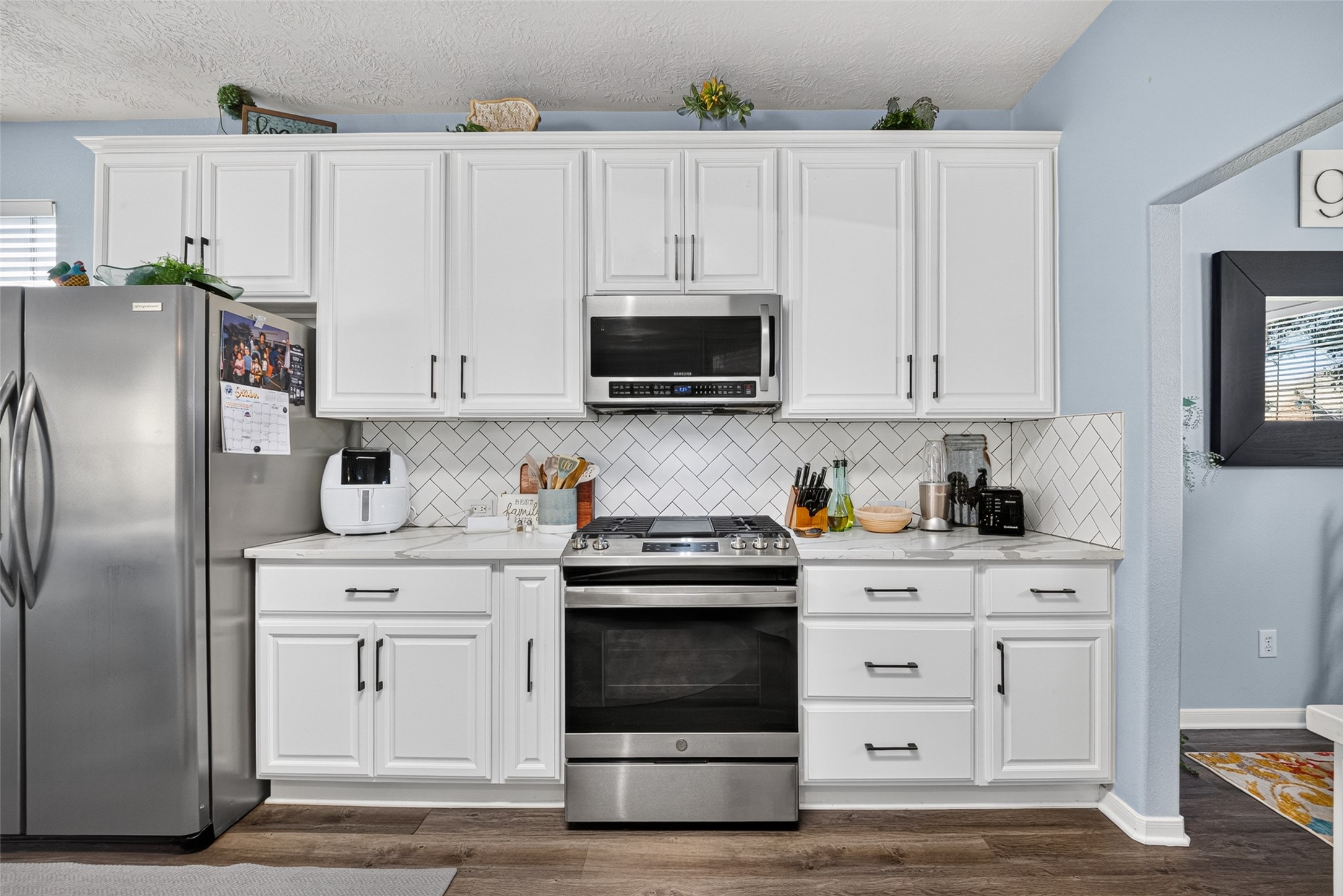 Bright kitchen with stainless appliances and plenty of storage.