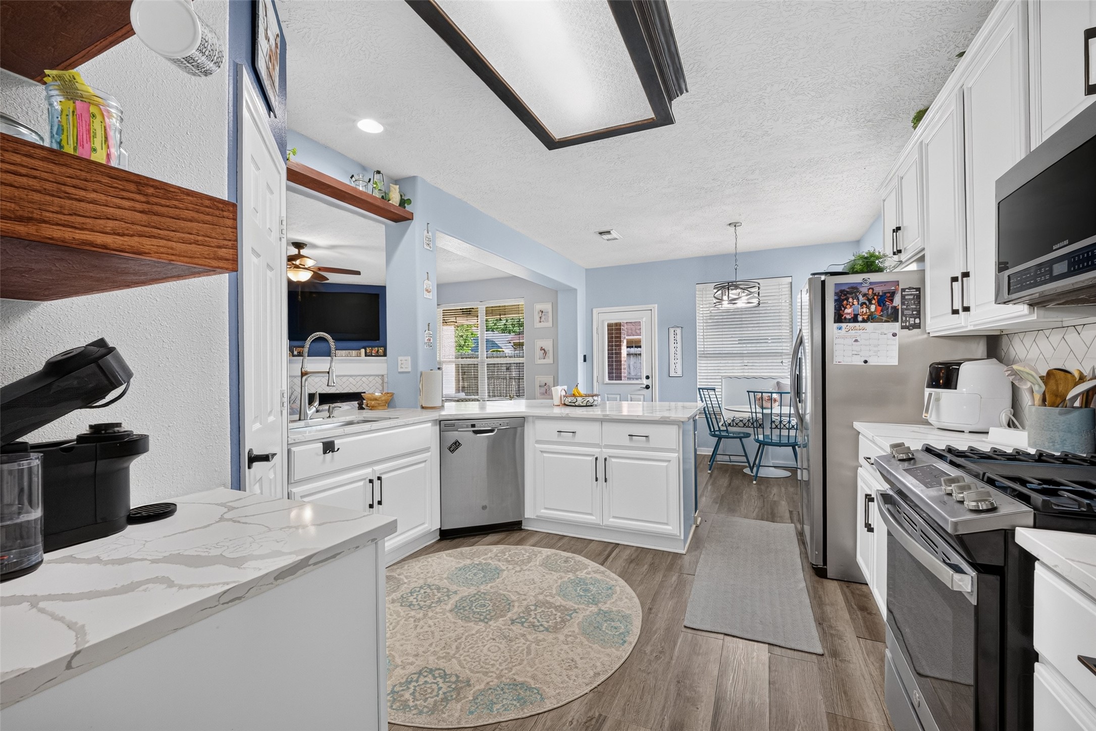Kitchen with a roomy island at its center  the heart of the home.