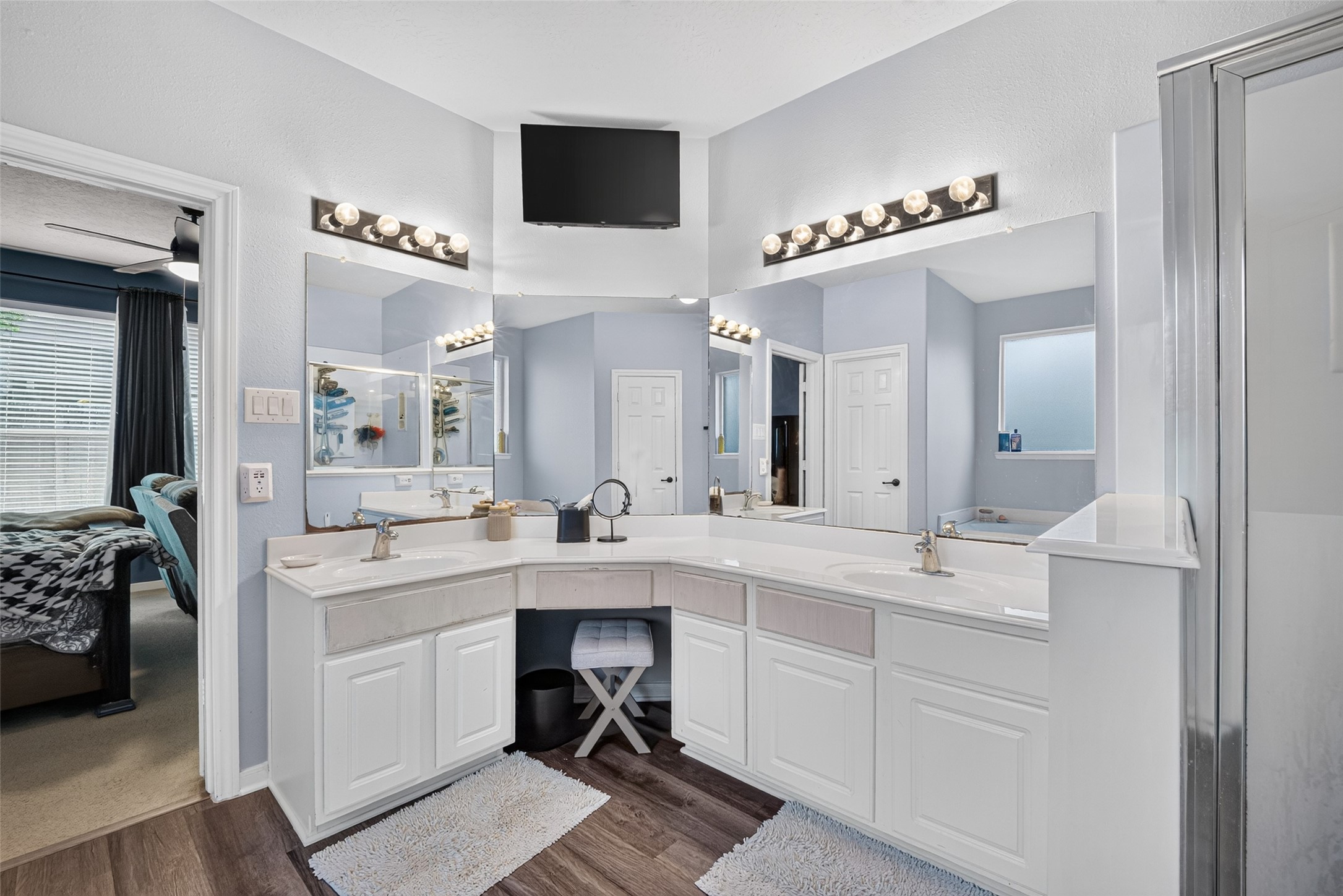 Primary bath with double vanity and shower/tub combo.