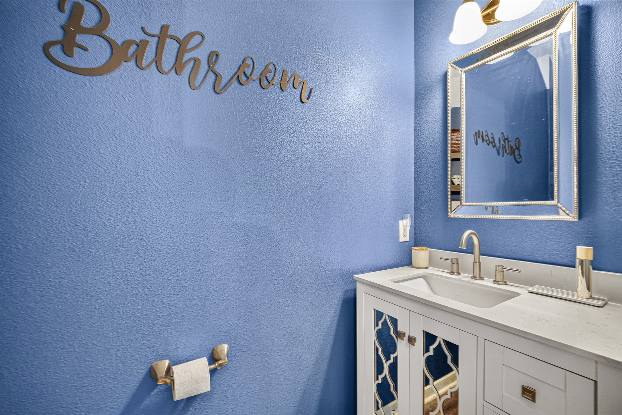 Convenient powder room with bold blue walls.