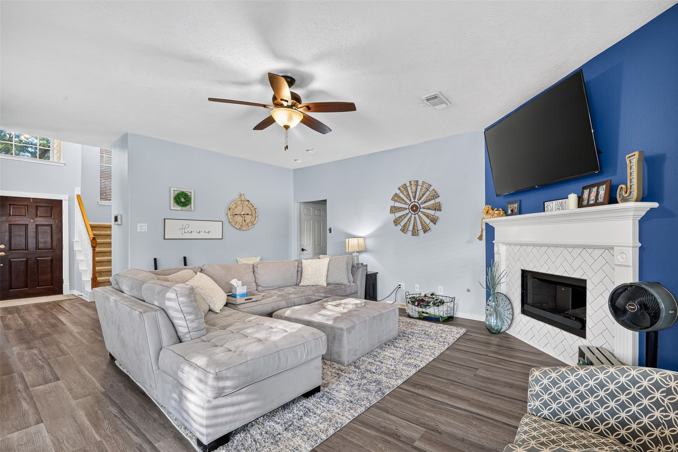 Living room anchored by a cozy fireplace, open to the kitchen. Living room anchored by a cozy fireplace, open to the kitchen.