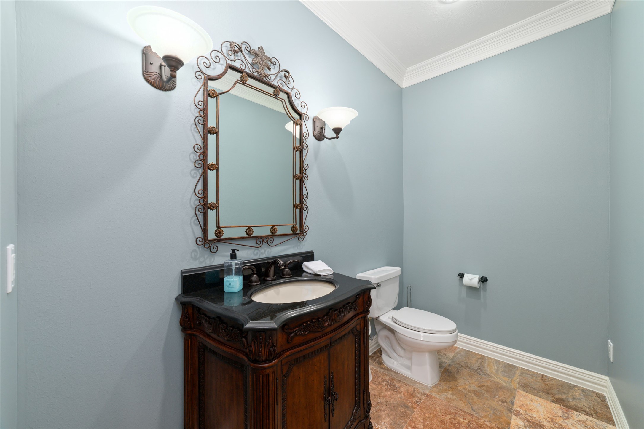 Half bath off the family room with easy access to the covered patio