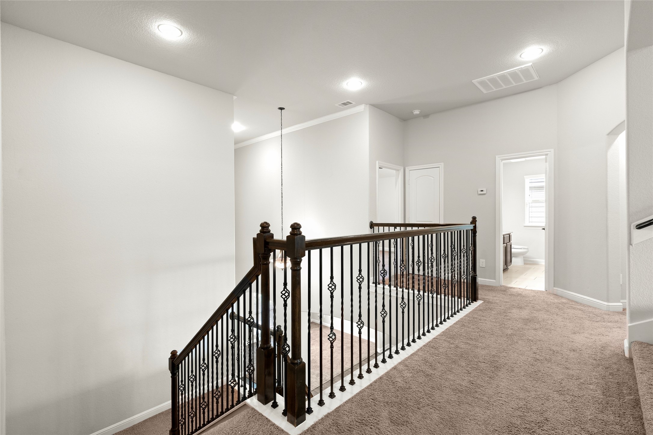 Upstairs landing with wrought-iron railing