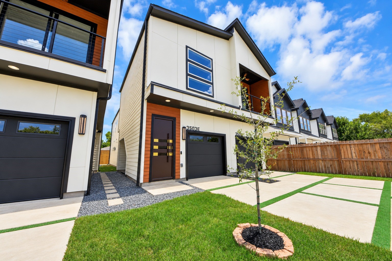 An inviting angled view highlights the duplex design, separate garages and thoughtfully defined entrances.