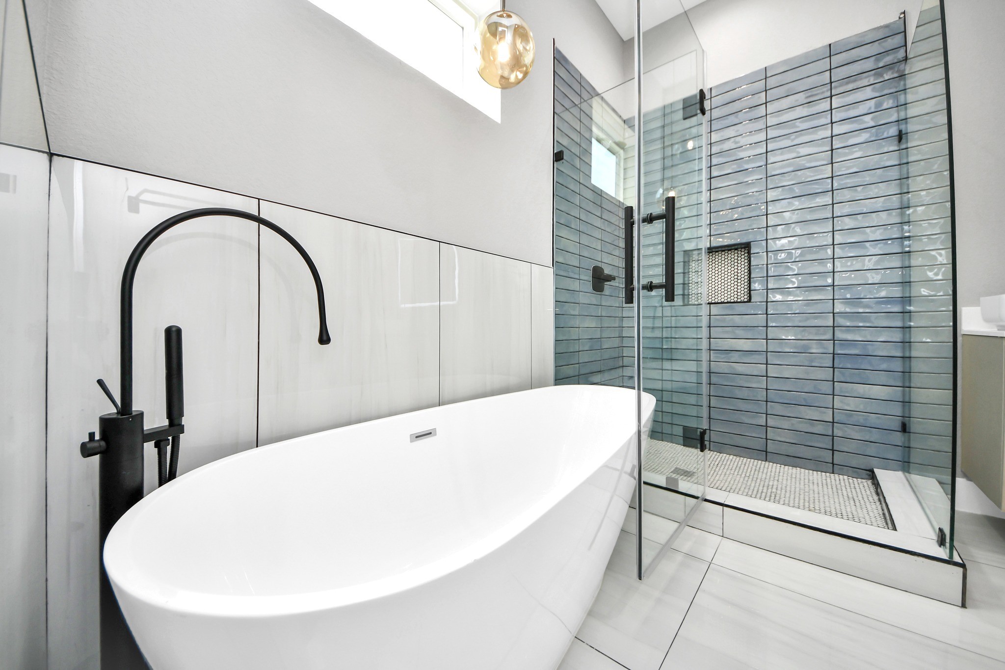 Unwind in the freestanding soaking tub or refresh in the oversized glass-enclosed shower.