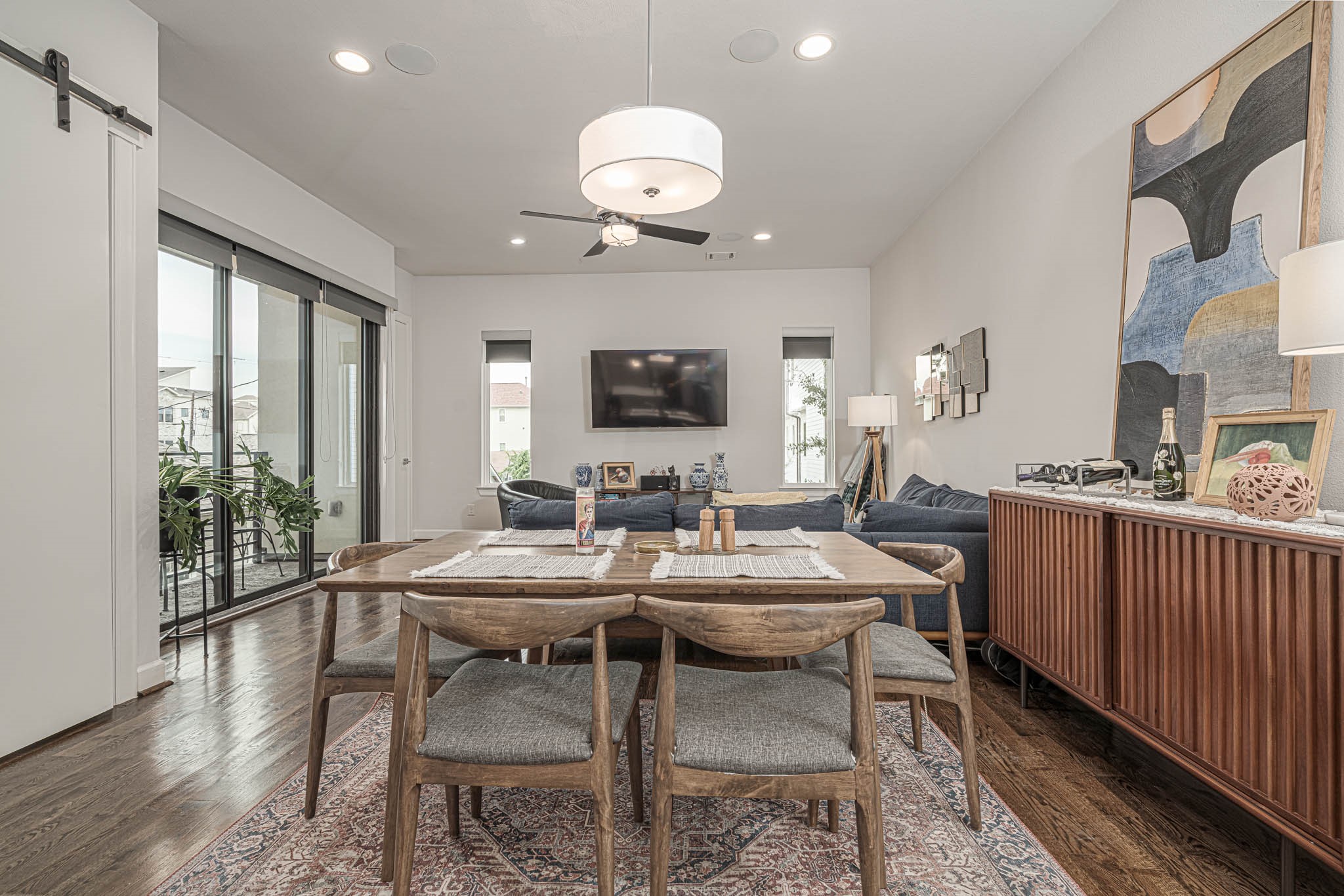 Elevate your lifestyle in this stylish second-floor living space, featuring an open concept with elegant dining, a cozy seating area, and abundant natural light from expansive sliding doors.