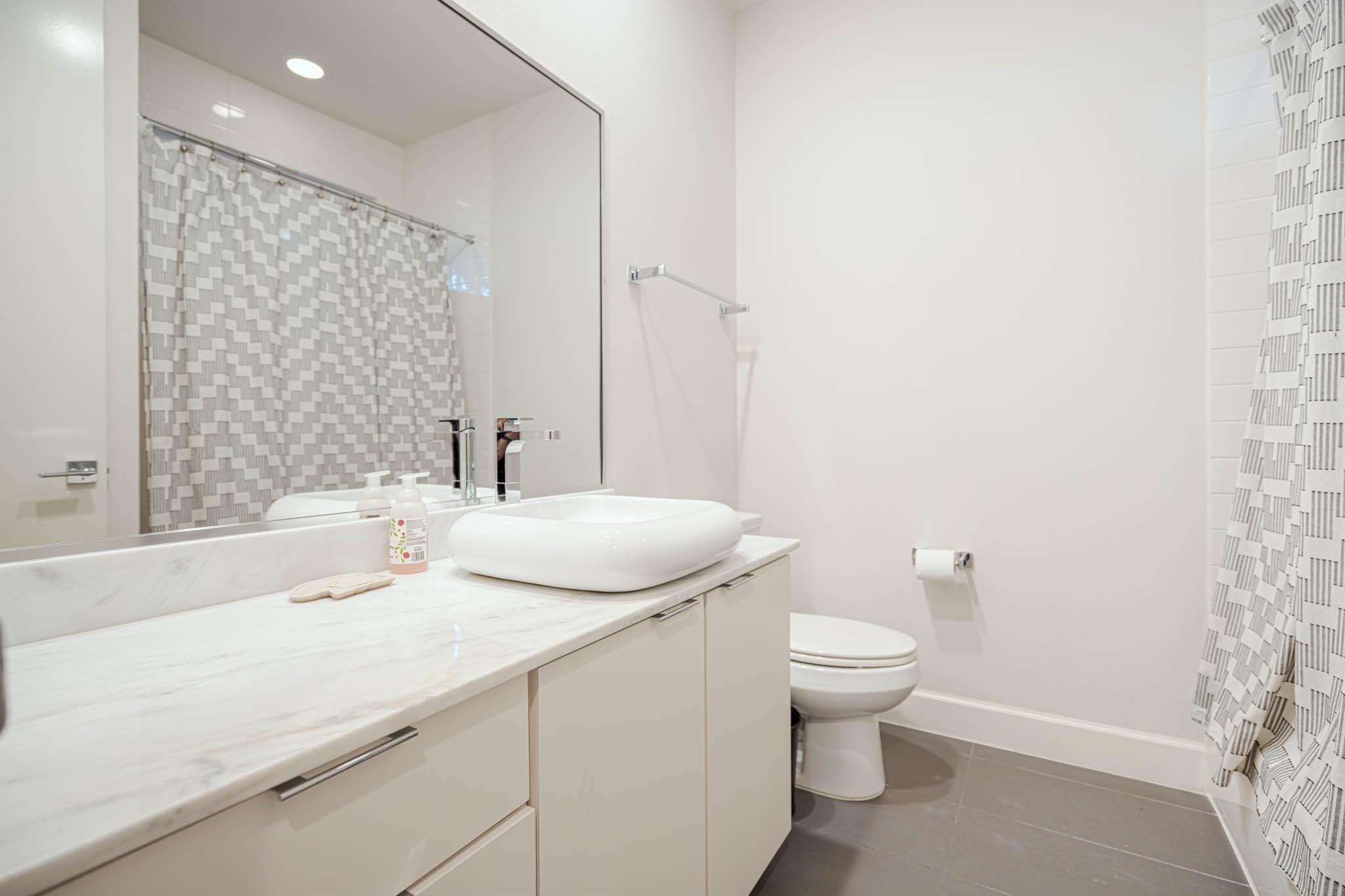 Experience convenience and luxury with the elegant full bathroom in the downstairs en suite bedroom, perfect for guests or private relaxation.