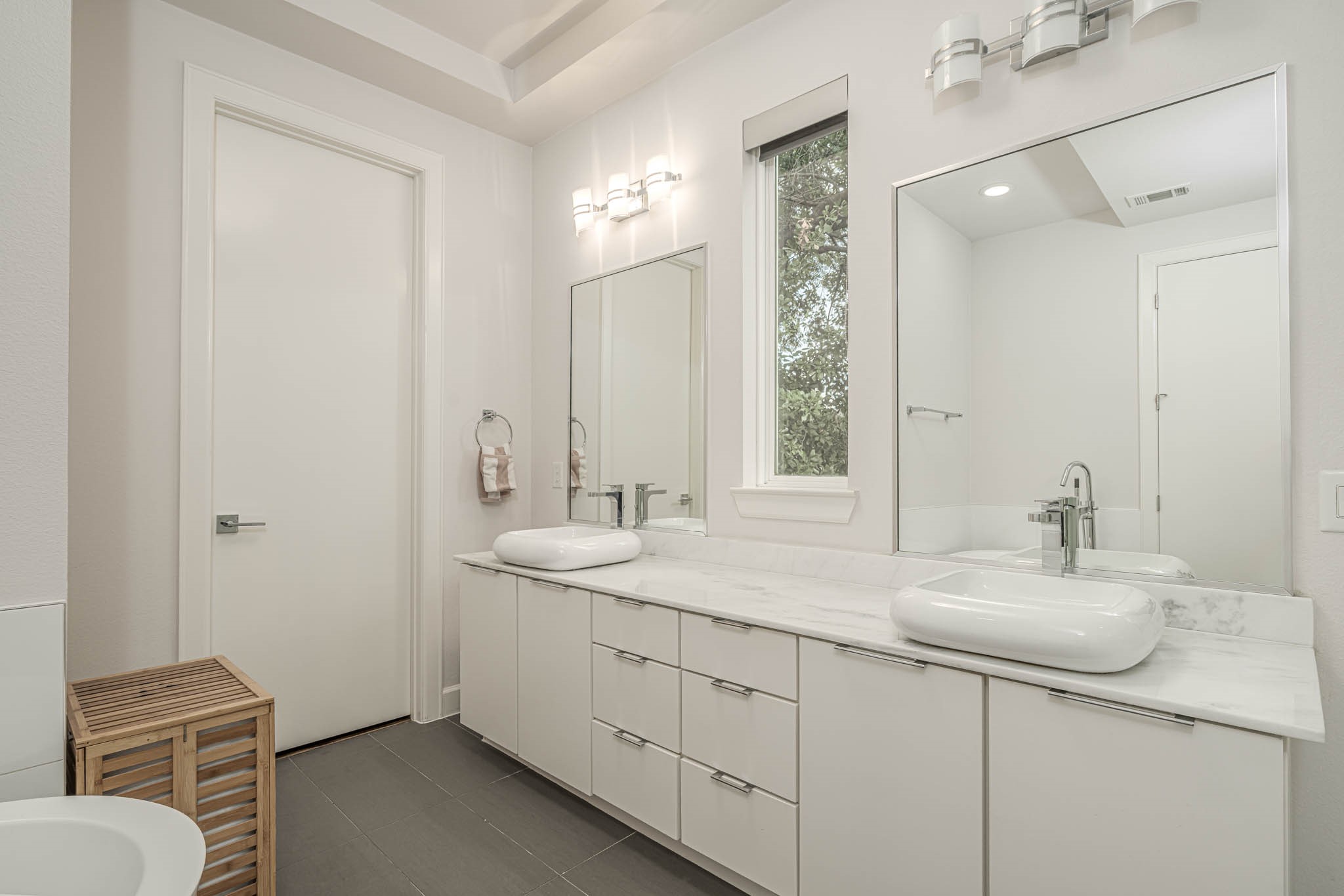 Experience luxury in the primary bathroom with elegant double sinks, a separate shower, and a relaxing bathtub, all designed for ultimate comfort.