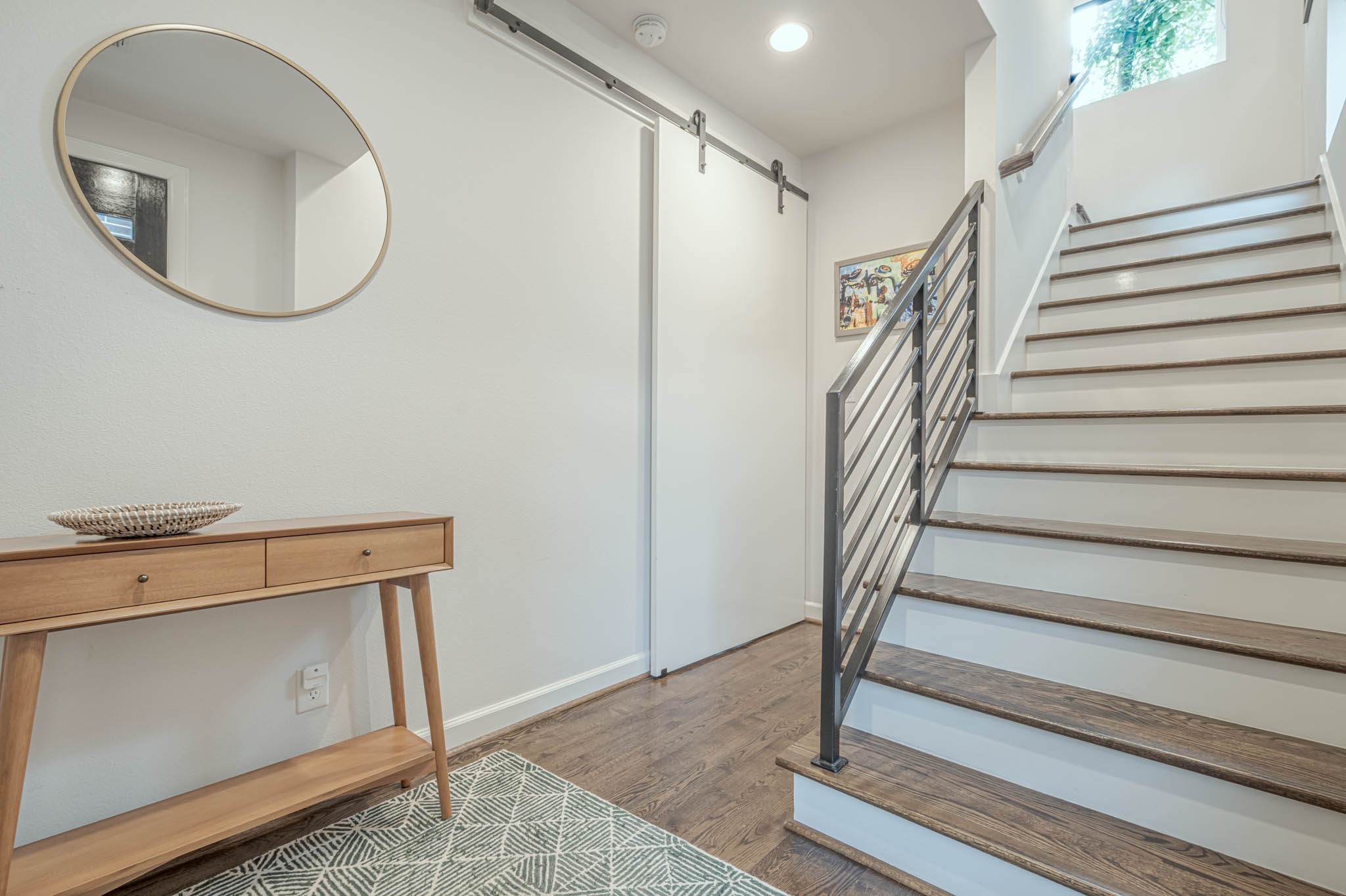 Step into a warm welcome with this inviting downstairs entry, where modern elegance meets functional design.