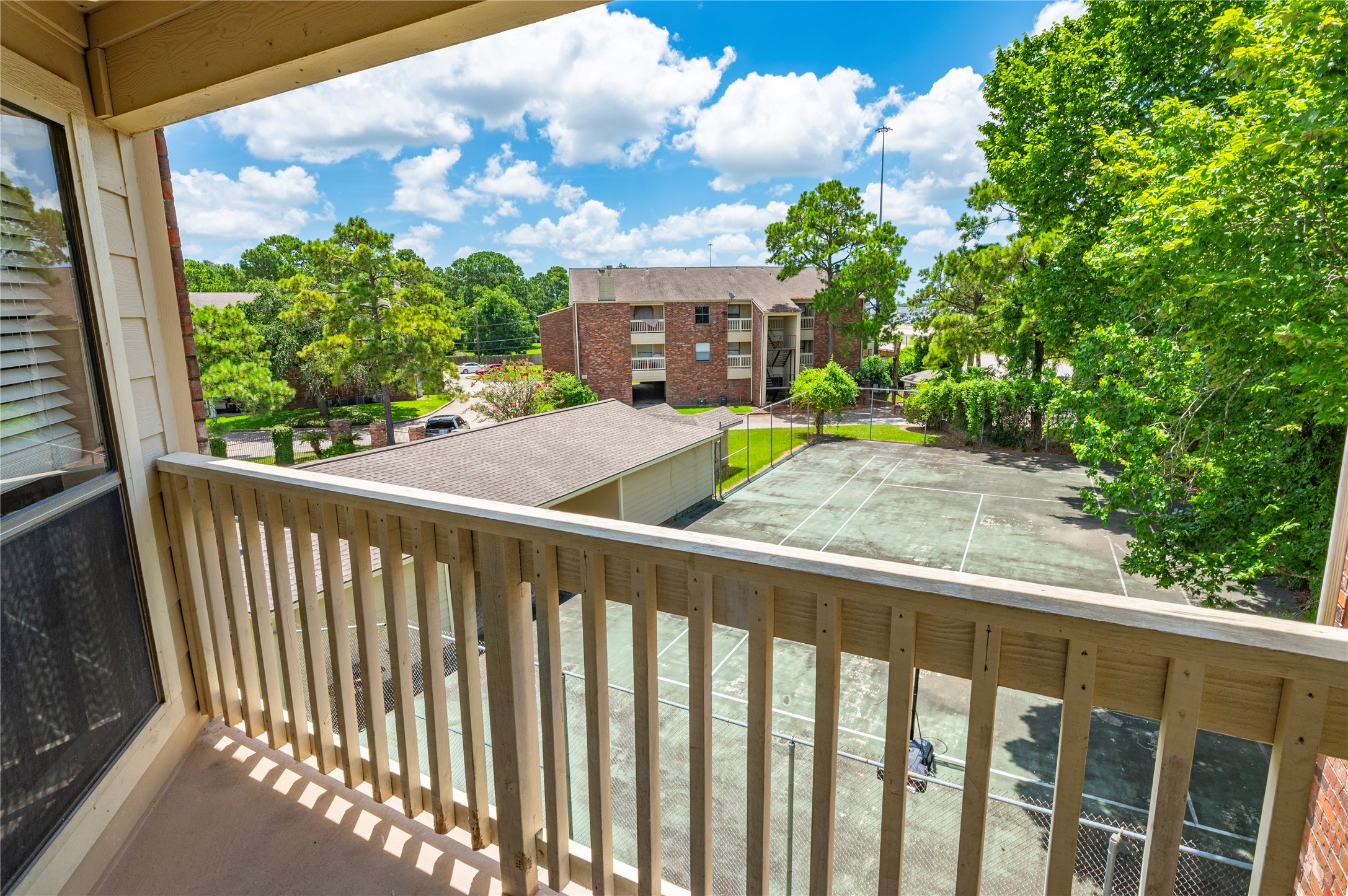 Living Room balcony looking over tennis court and main entrance
