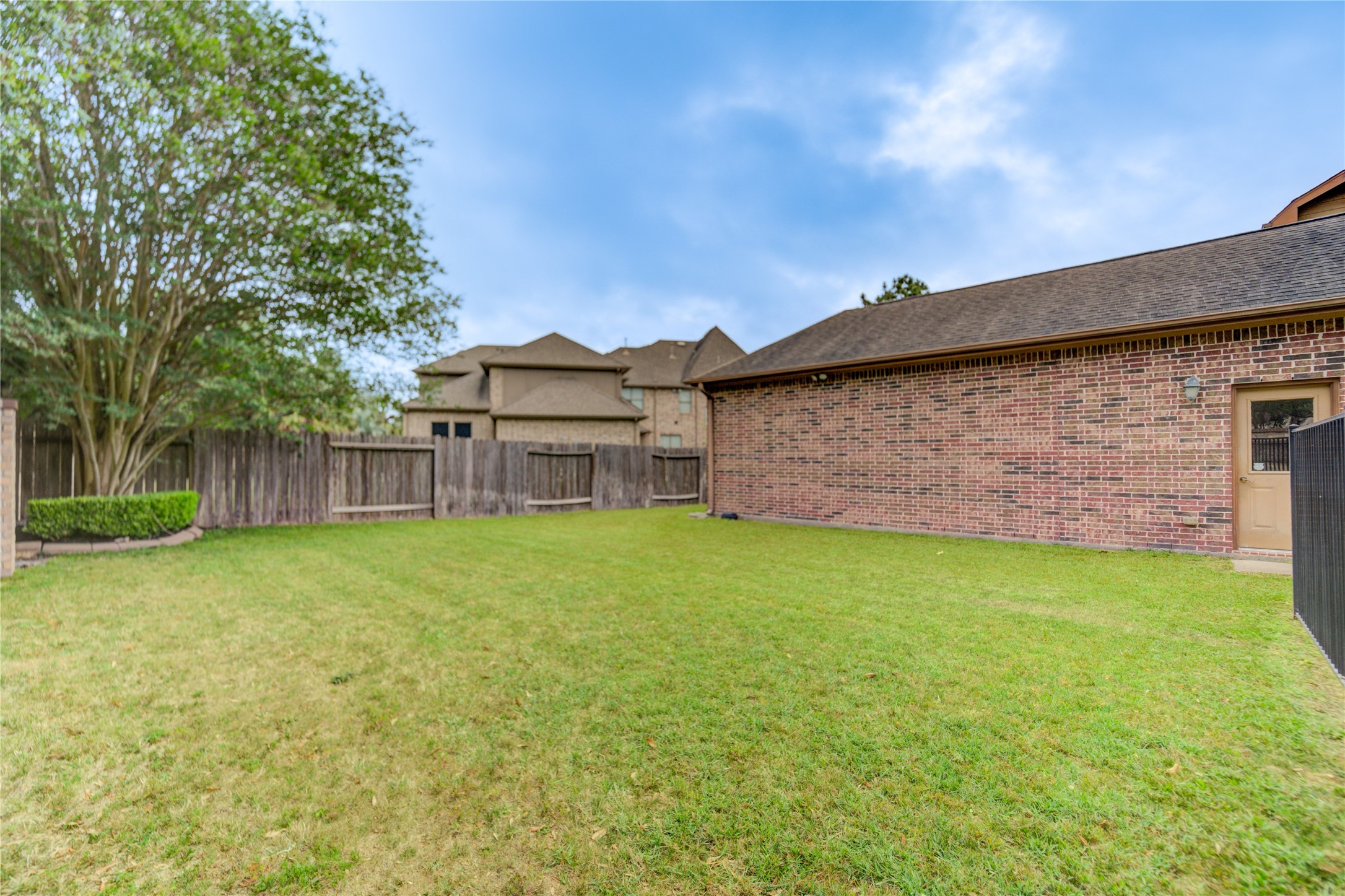 Expansive green area provides the perfect setting for family fun or pets to enjoy the outdoors.