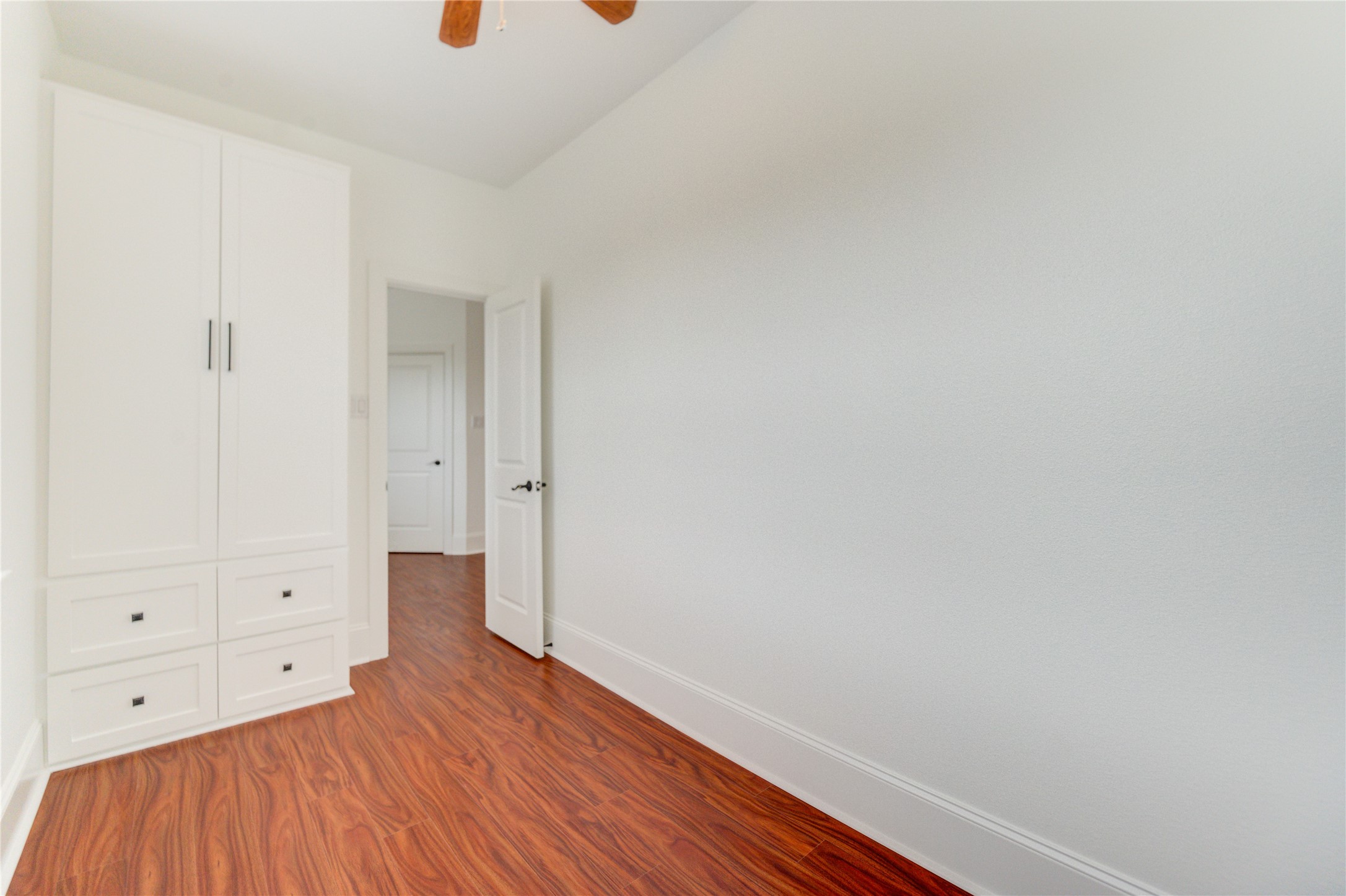 Thoughtfully designed upstairs storage with built-in shelving and ample closet space.