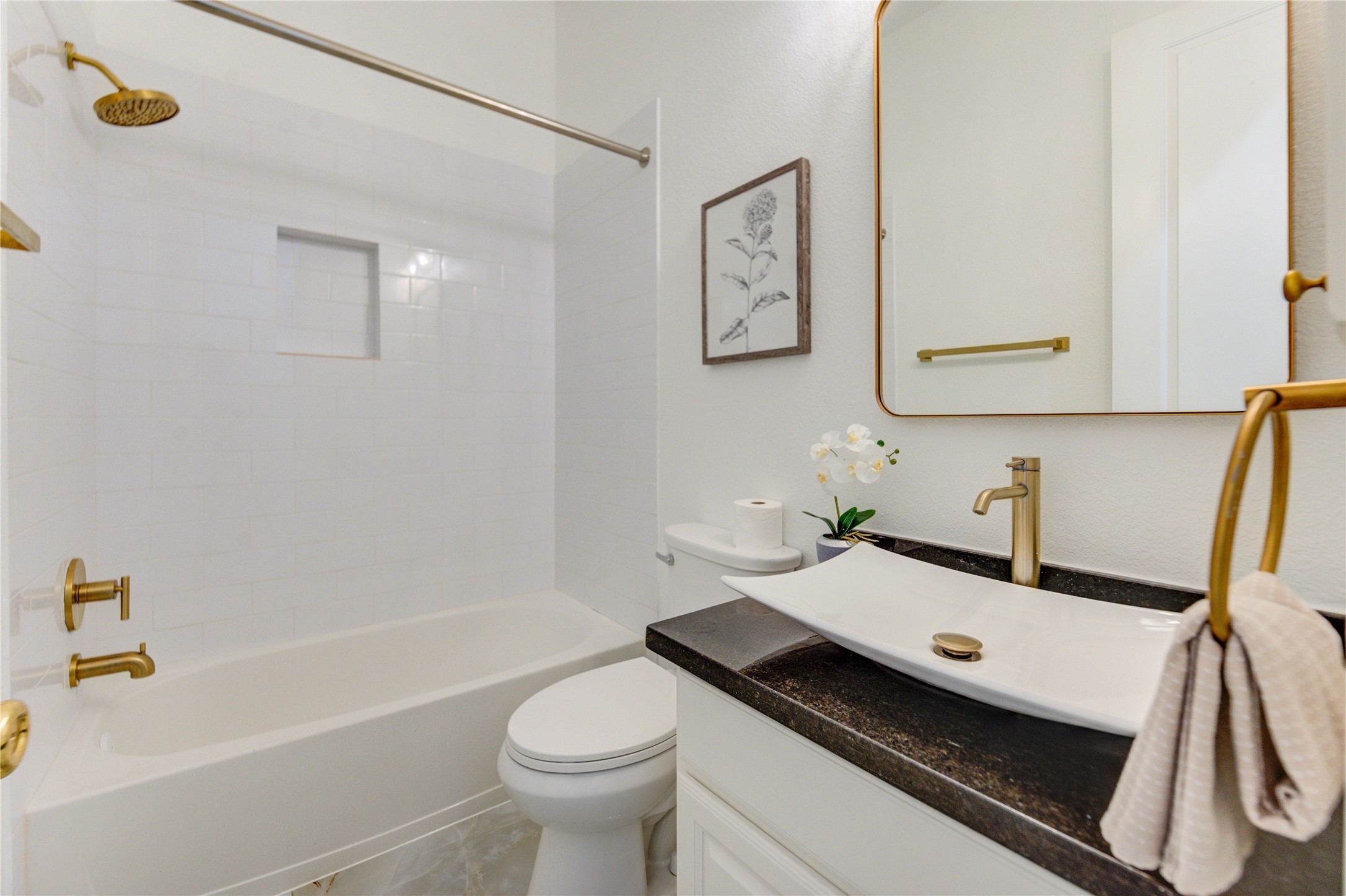 The first-floor guest suite features a private full bathroom, offering comfort and convenience for visitors.