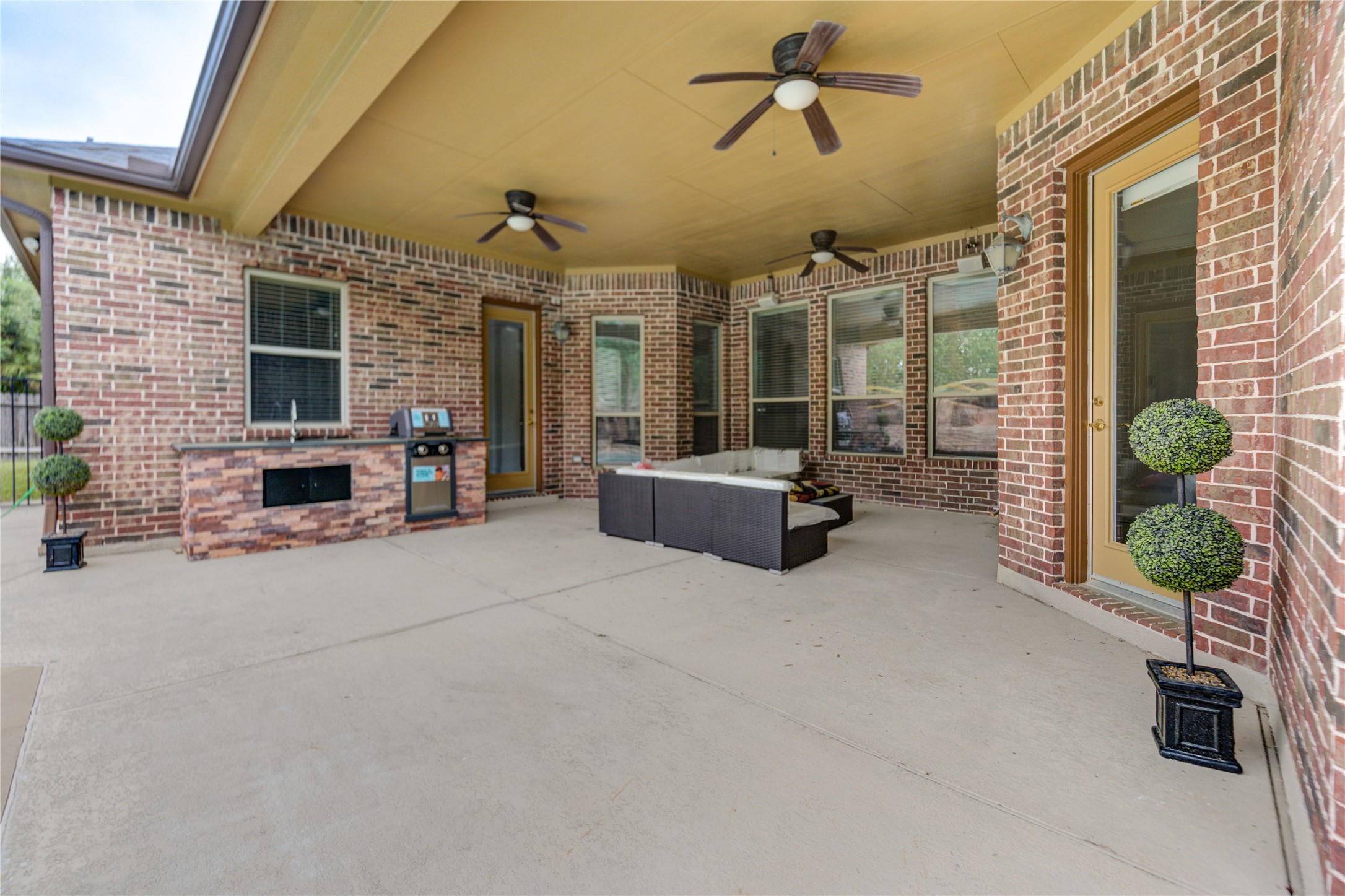 Enjoy a covered patio equipped with a brand-new grill and sink, perfect for hosting elegant poolside events.