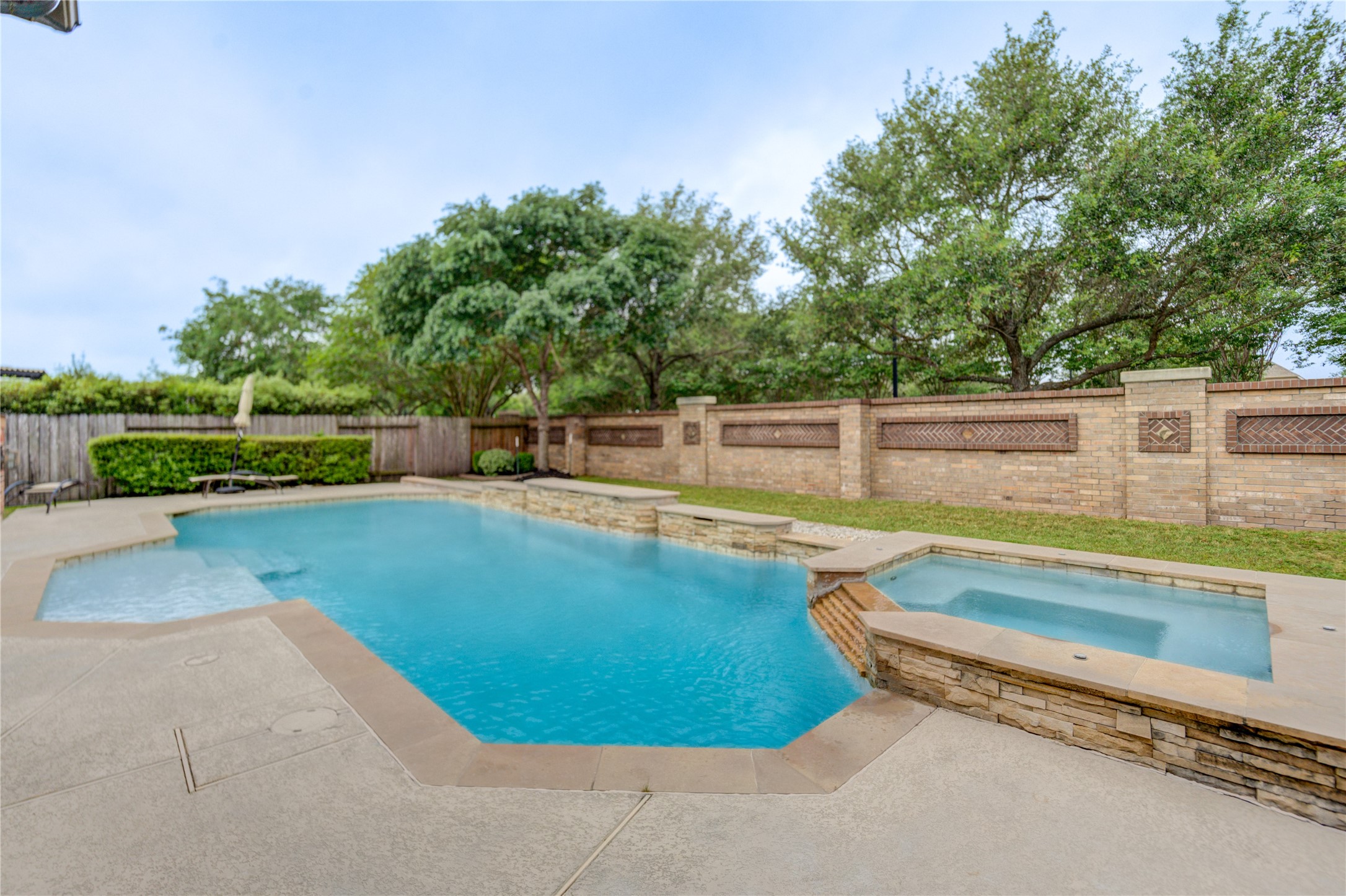 A luxurious heated pool with a connected hot tub, offering ultimate enjoyment in every season.