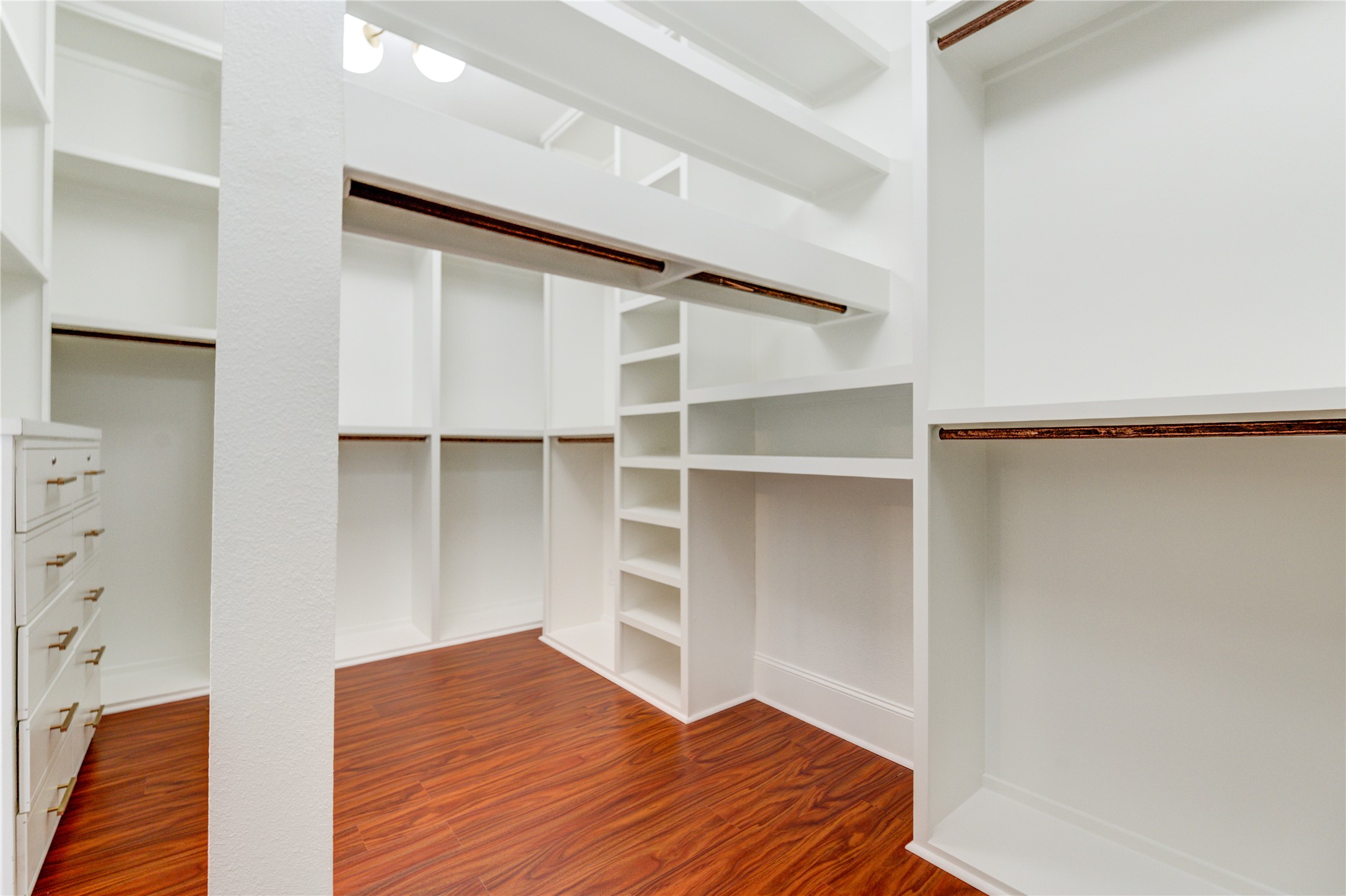 The primary suite boasts a thoughtfully designed walk-in closet with custom built-ins and plenty of hanging space, combining luxury and functionality.