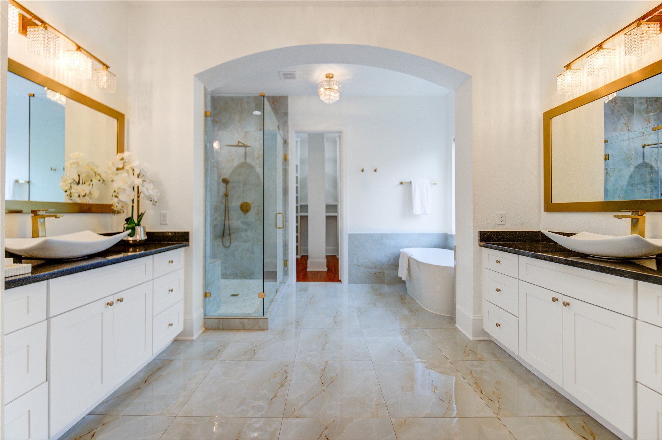 The primary bathroom has been exquisitely renovated, offering separate vanities, a generous shower, and a deep soaking tub for ultimate relaxation.