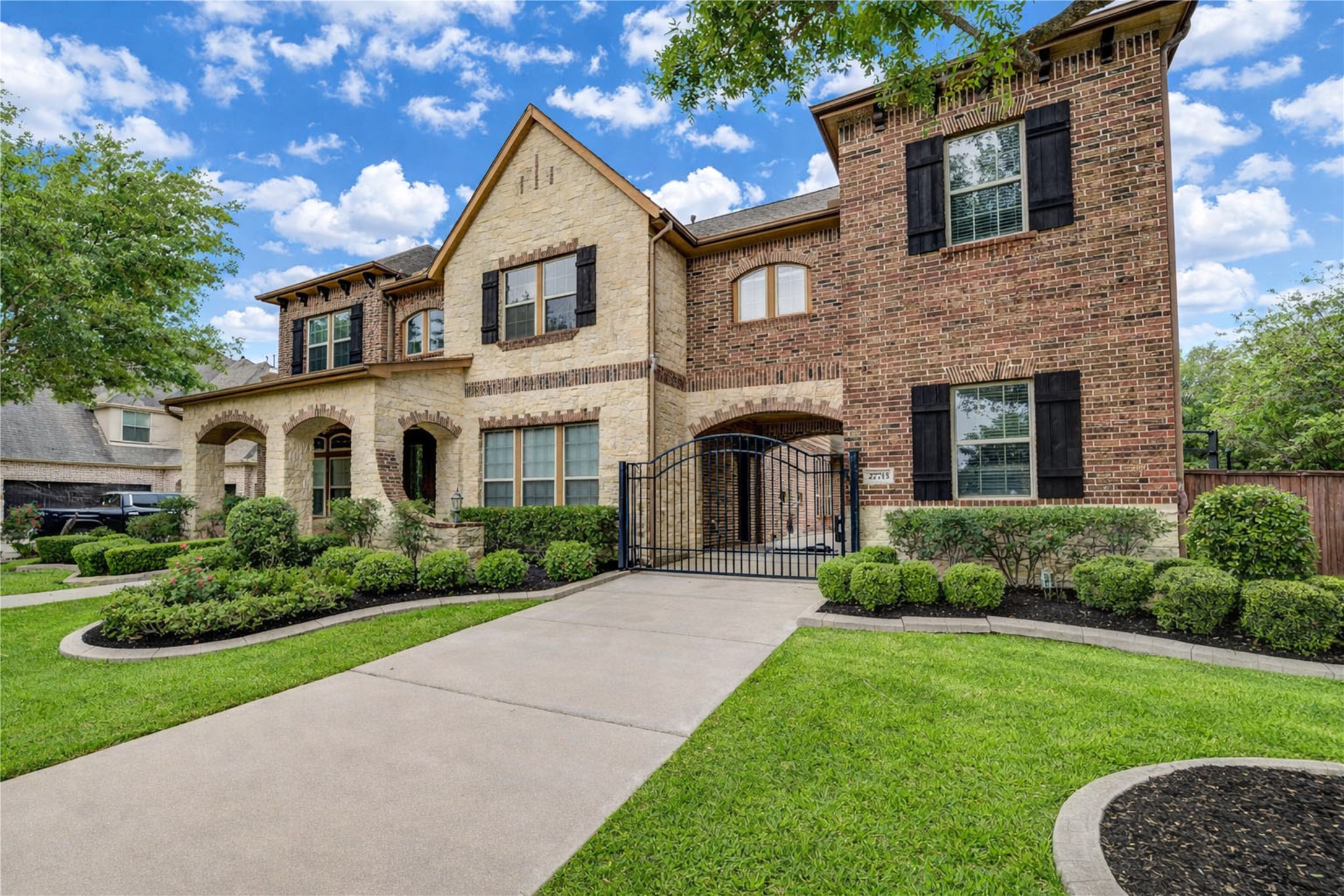 An elegant brick exterior complemented by a inviting front porch and a gated driveway for privacy and curb appeal.