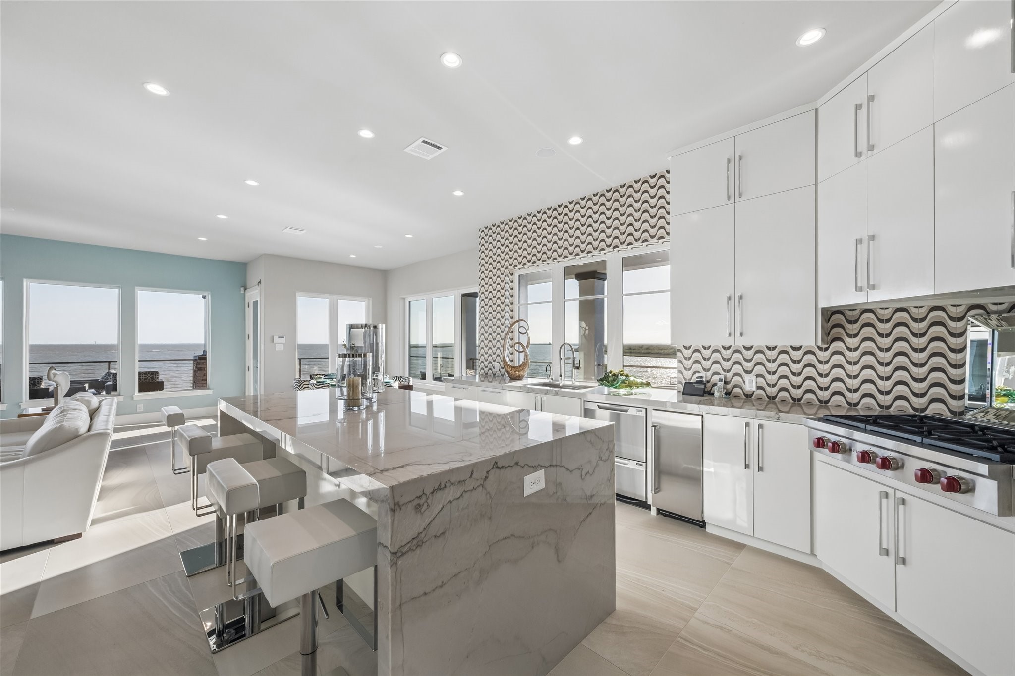 This kitchen delivers a clean blend of luxury and performance, opening directly to the living area with bay views from nearly every angle. The layout is bright, functional, and designed for both everyday living and entertaining