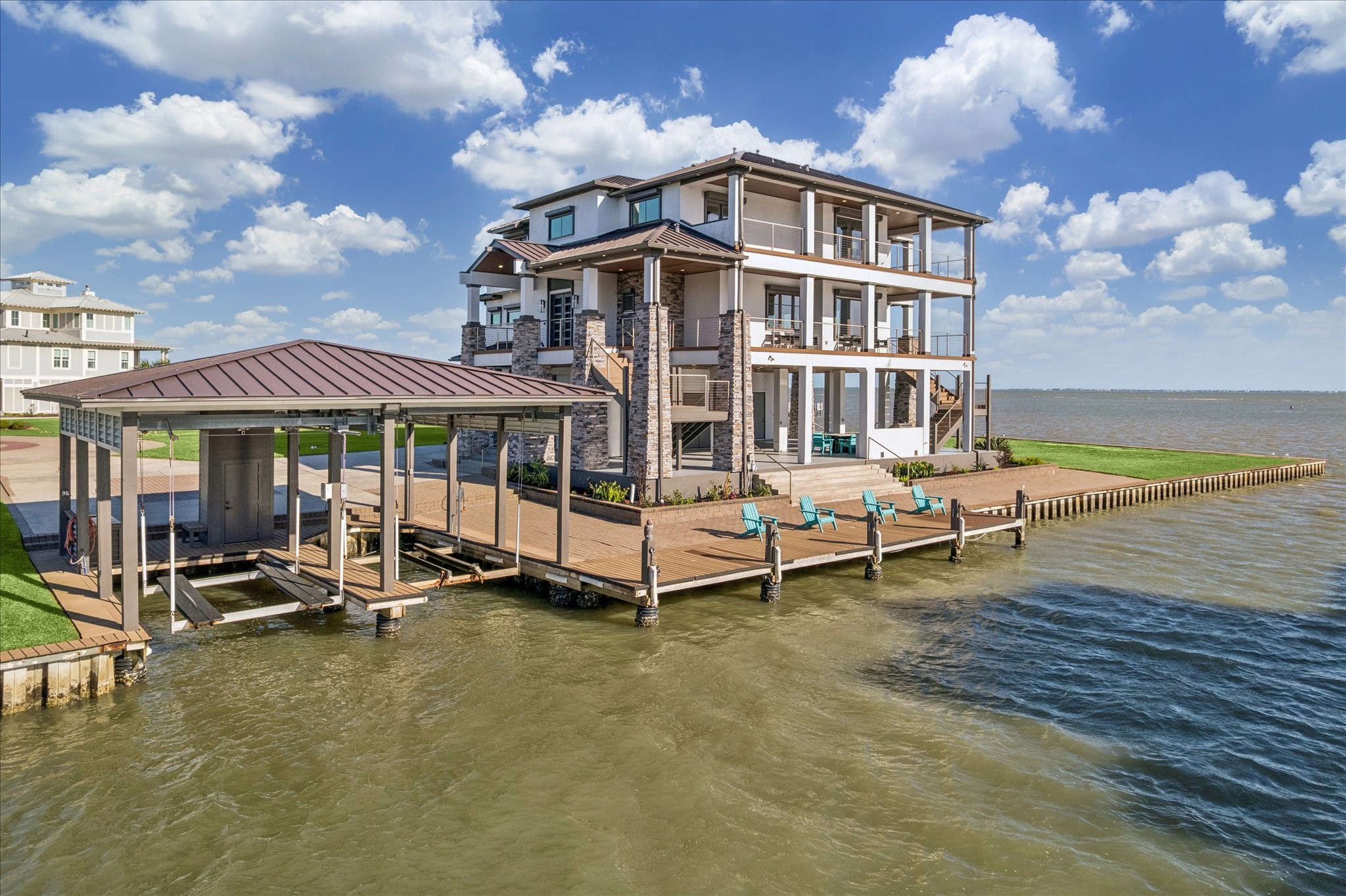 This modern retreat offers unobstructed views of West Galveston Bay and the Intracoastal Waterway from expansive multi-level covered balconies. Designed for boating enthusiasts, it features a private double boathouse with lifts and a pier with a lounge dock. The prime waterfront setting completes this exceptional Harborwalk sanctuary