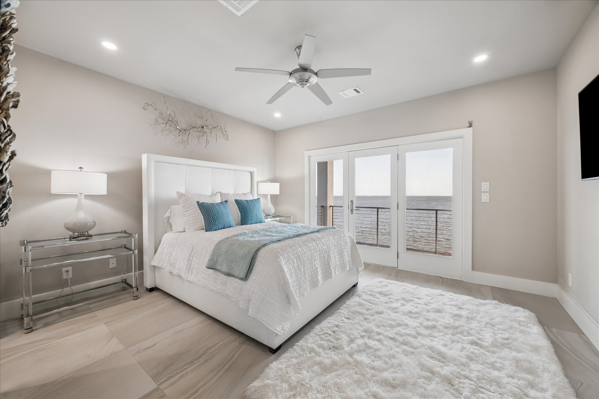 One of three second-level guest bedrooms, offering walk-in closet, direct access to a full bathroom and a covered balcony