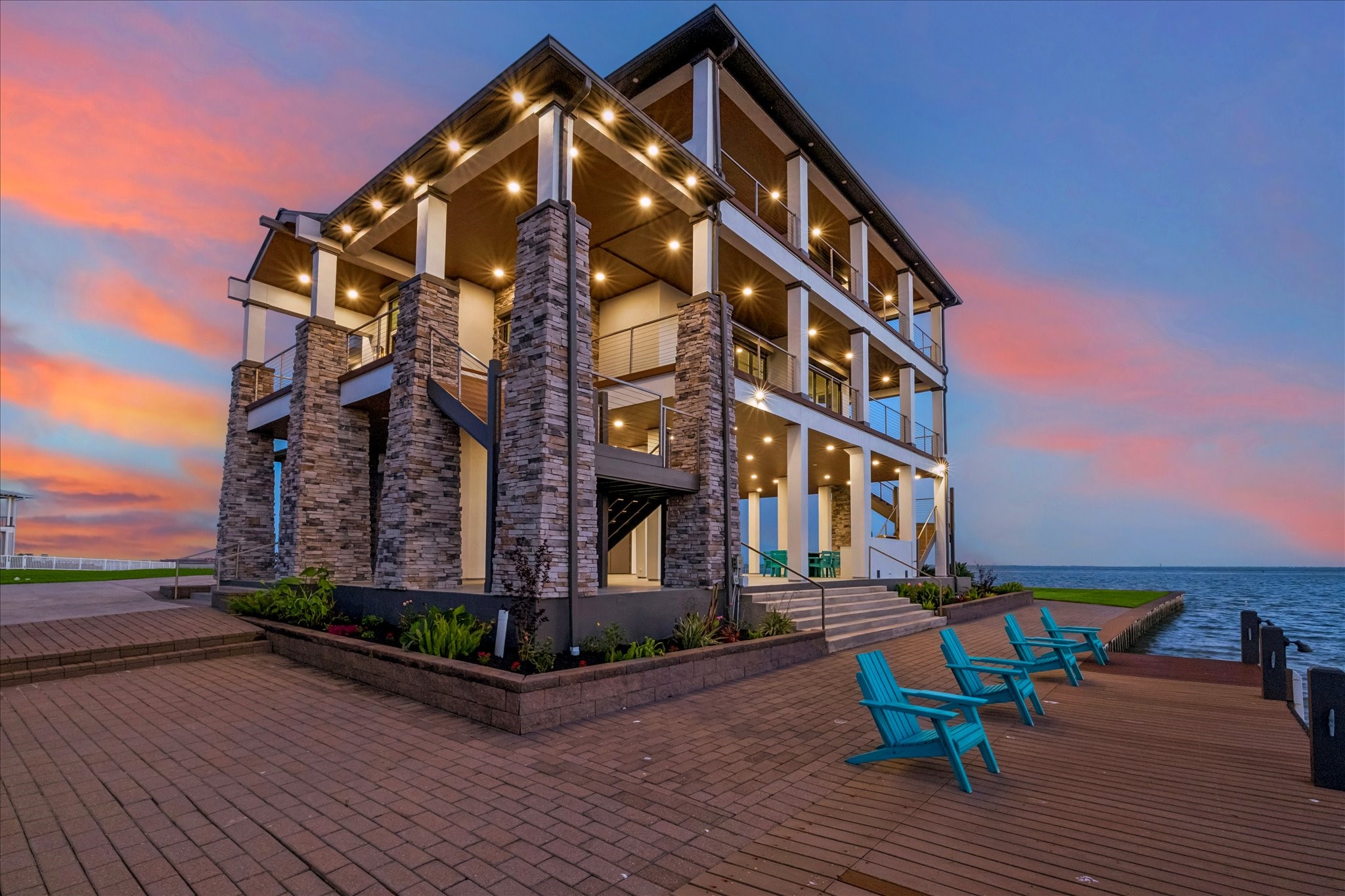 Elegant paver stone walkways surround the home, delivering a clean, sophisticated look with effortless maintenance, complemented by a dedicated dock and lounge area that offers breathtaking views