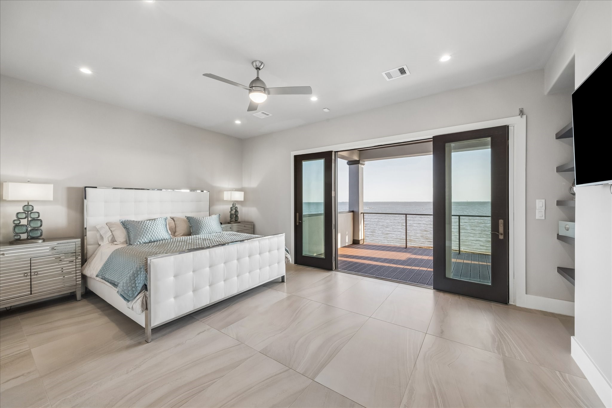 Primary bedroom showing the French doors open to the balcony