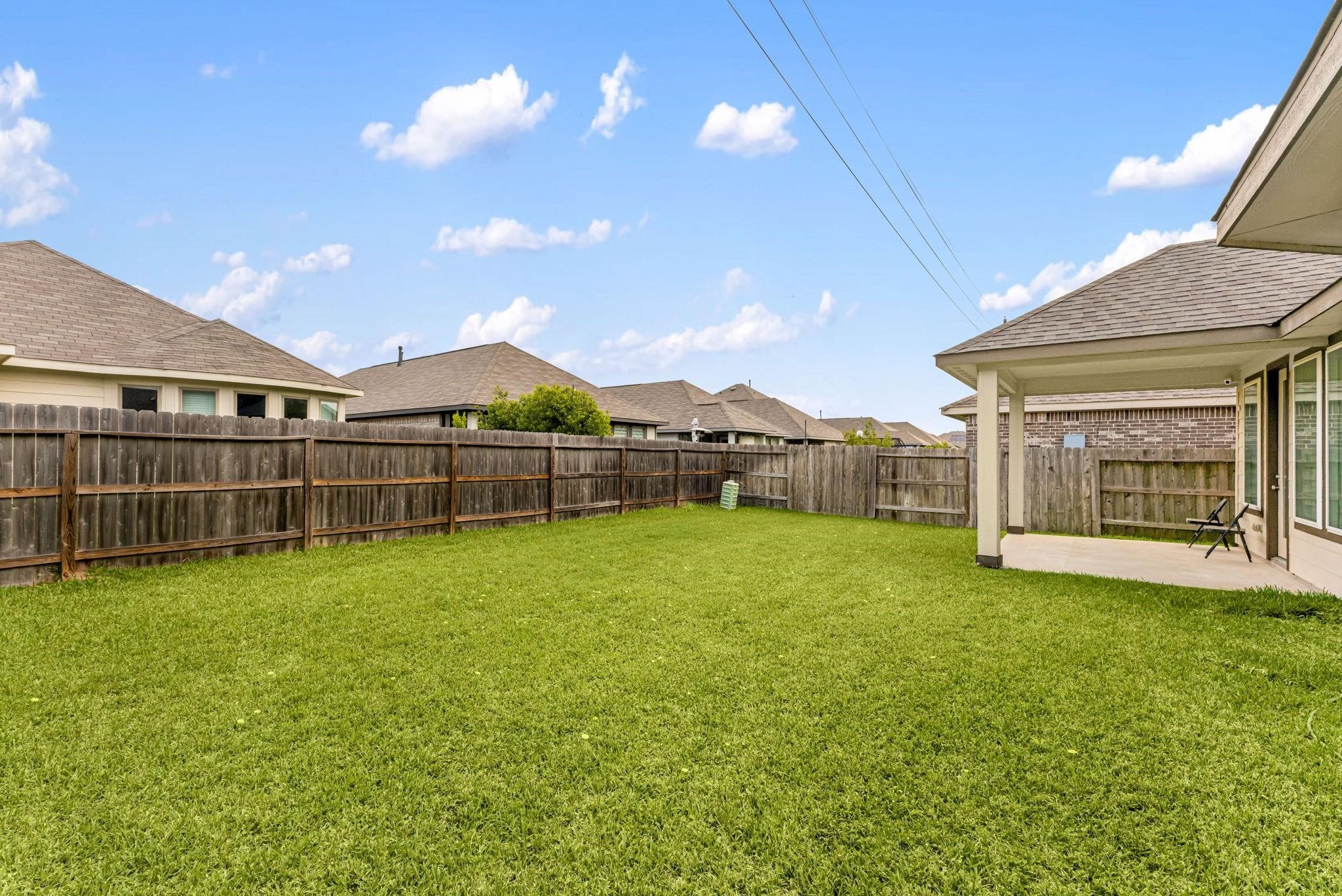 A huge, fully fenced backyard with endless room to run, garden, or relax outdoors.