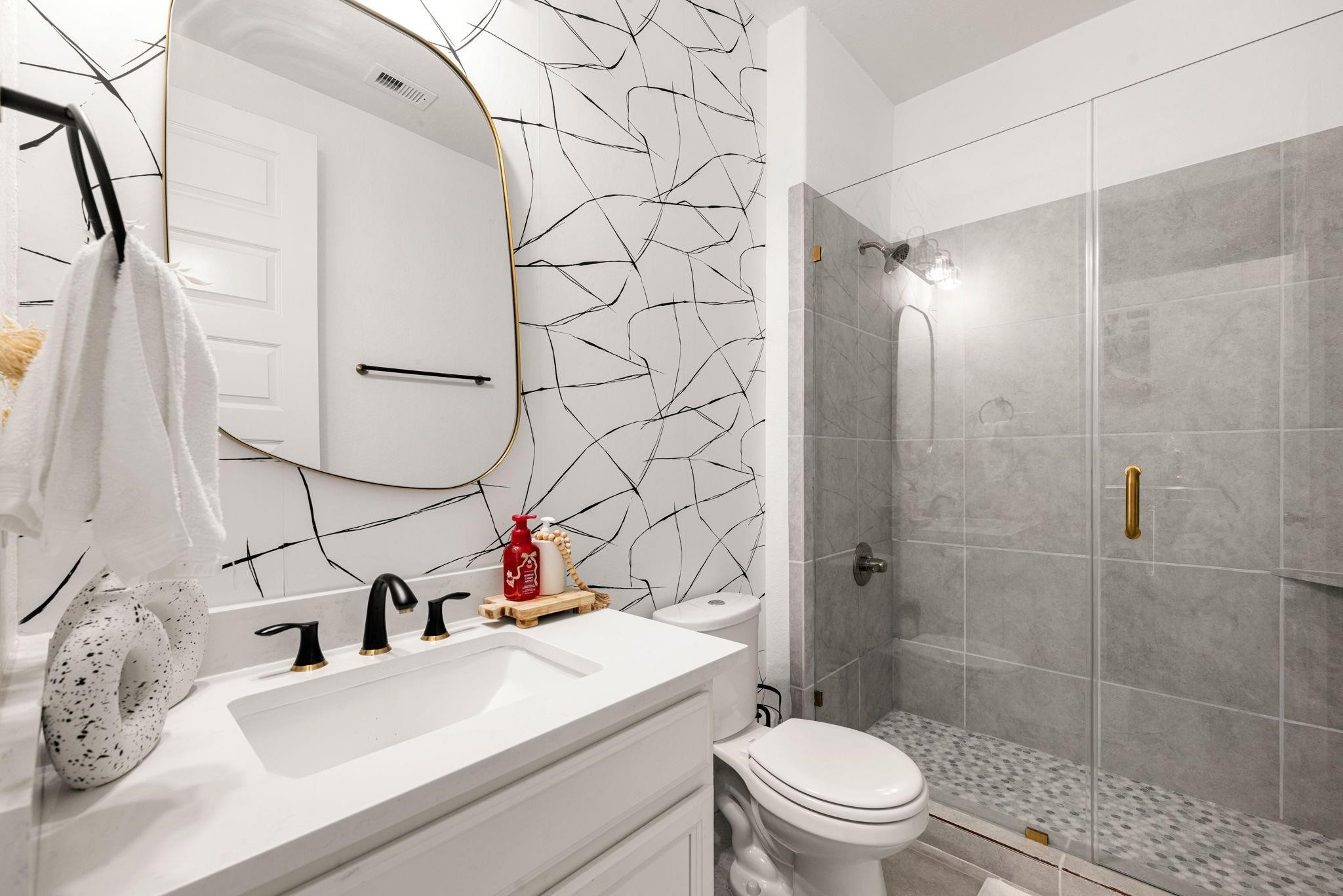 A clean full bath with a sleek vanity, serving the main floor bedroom and visitors.