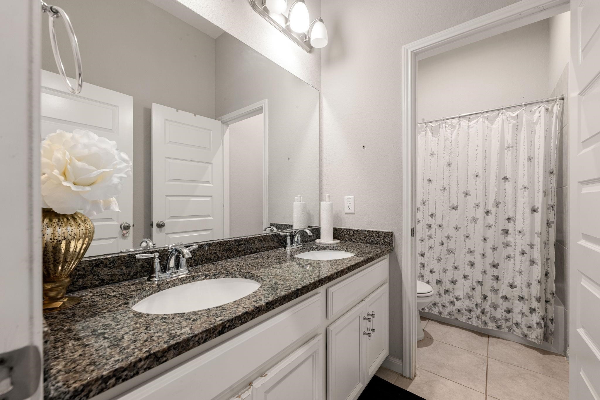 A dual-sink vanity set outside the full bathroom makes morning routines super easy for everyone upstairs.