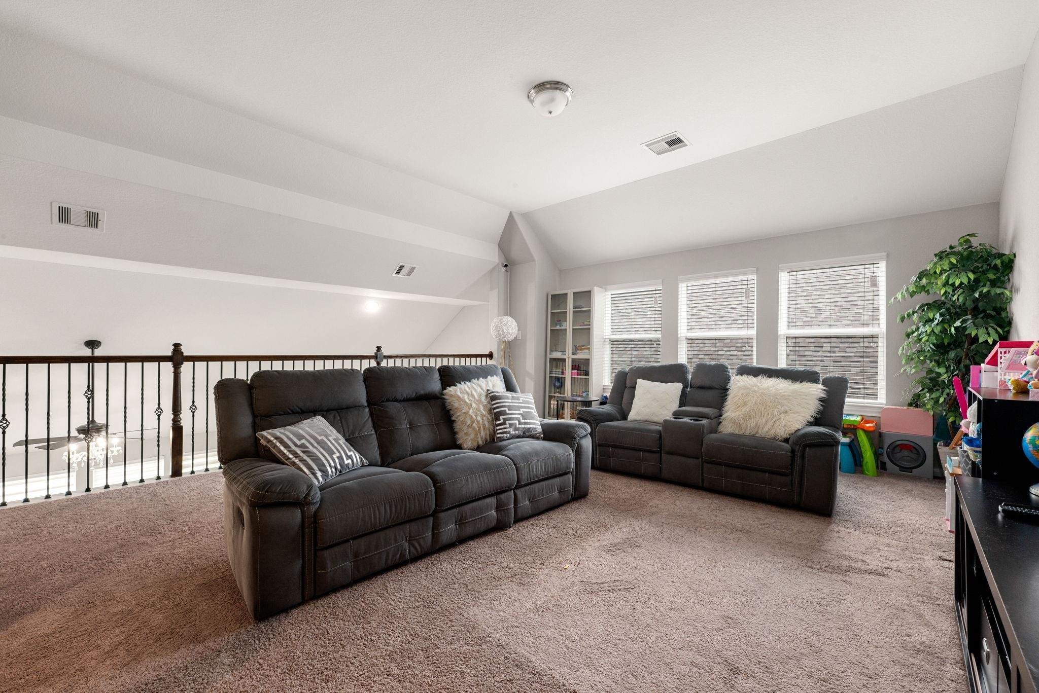 The upper landing opens up into a big, bright game room with plenty of space for recreation and lounging.