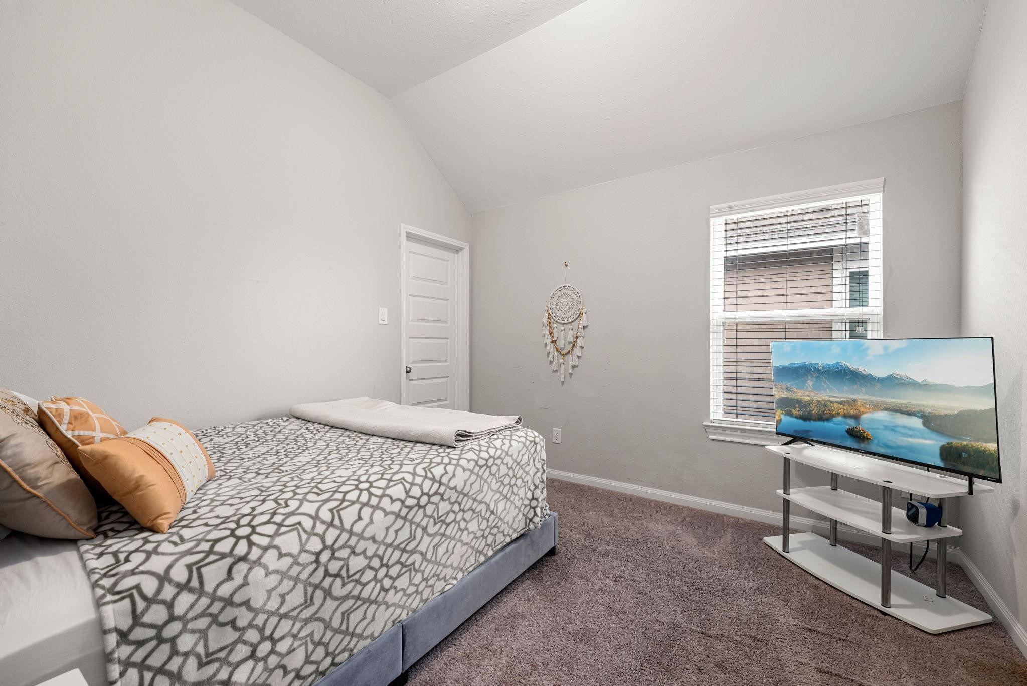 A comfortable upstairs bedroom with high ceilings and great floor space.