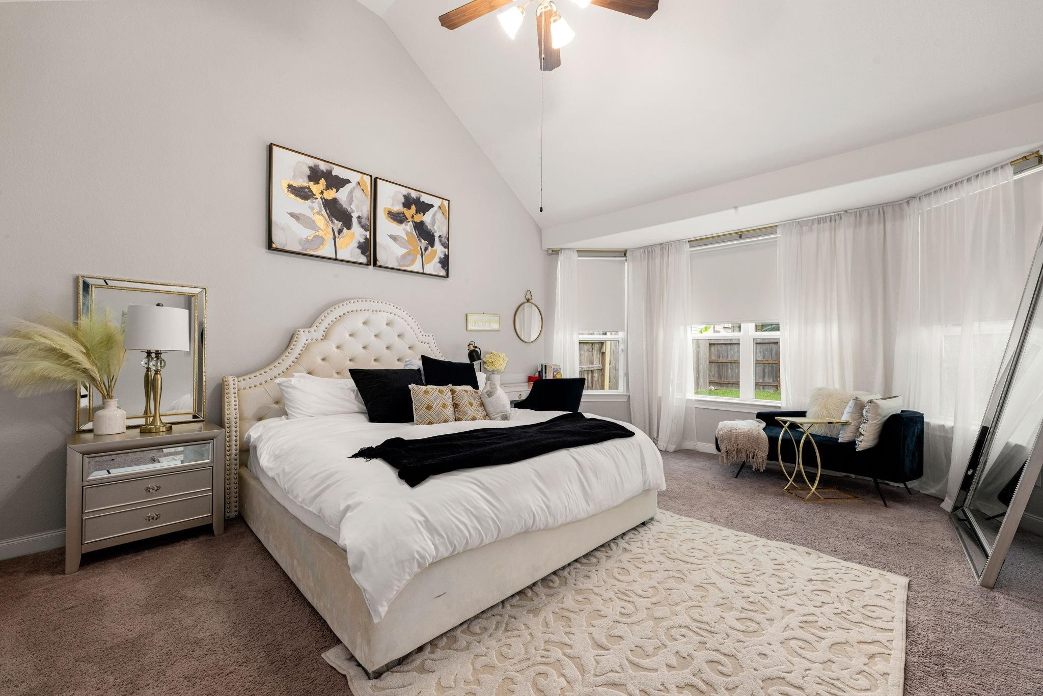 The primary bedroom offers a peaceful haven to unwind at the end of the day, with soft carpet and views of the backyard.
