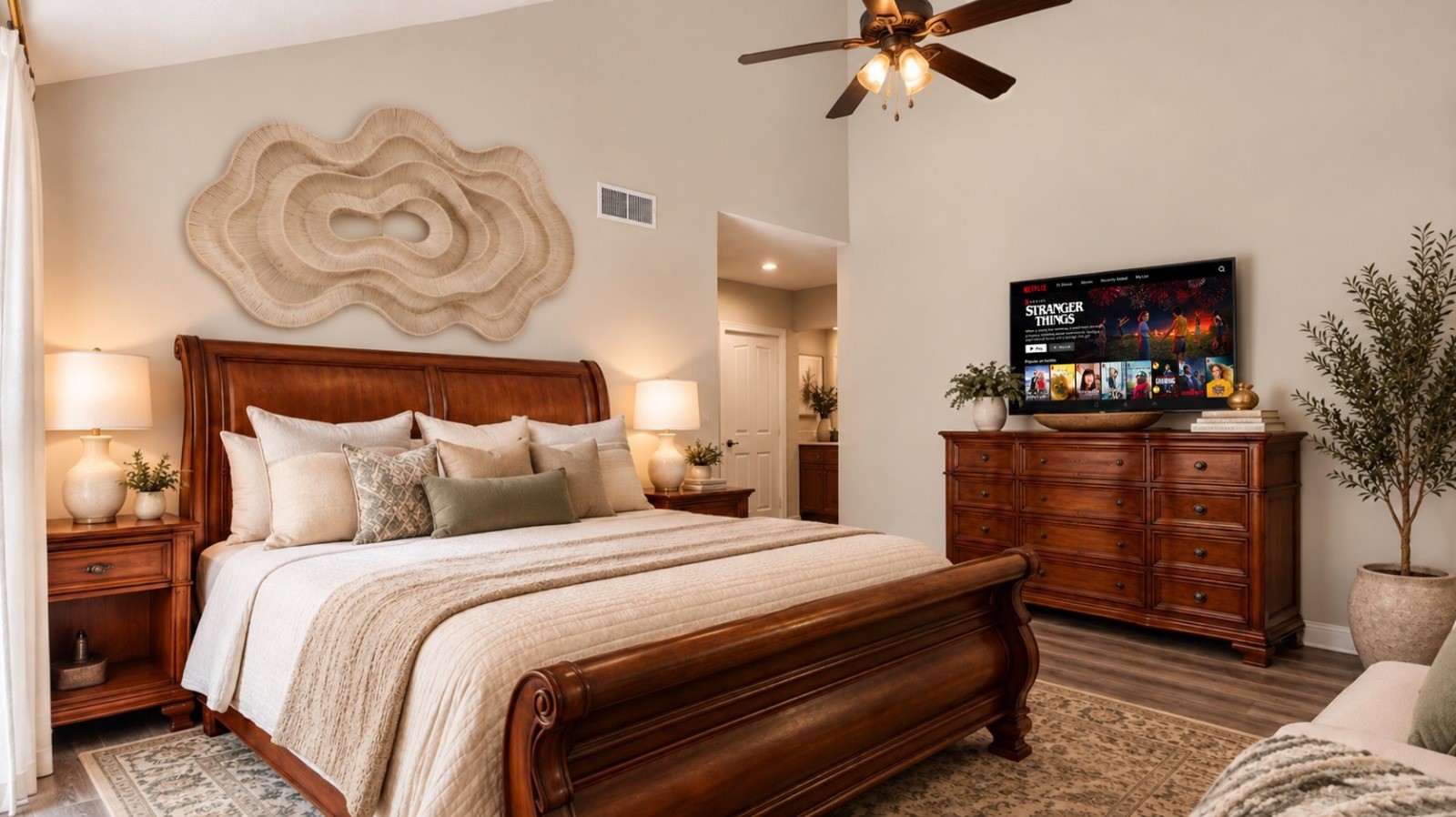 Primary Bedroom: Spacious primary bedroom featuring a classic wood bed frame, ceiling fan, warm neutral tones, and stylish decor for a comfortable retreat. Primary Bedroom: Spacious primary bedroom featuring a classic wood bed frame, ceiling fan, warm neutral tones, and stylish decor for a comfortable retreat.