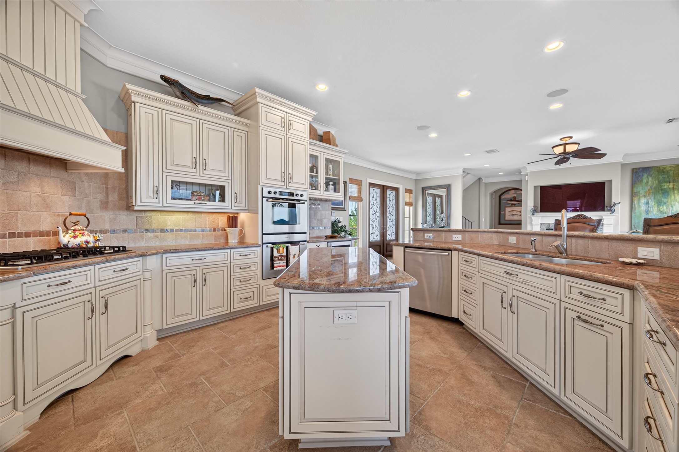 Elegant kitchen featuring custom cabinetry, granite countertops, and a spacious center island, perfect for entertaining and culinary adventures.