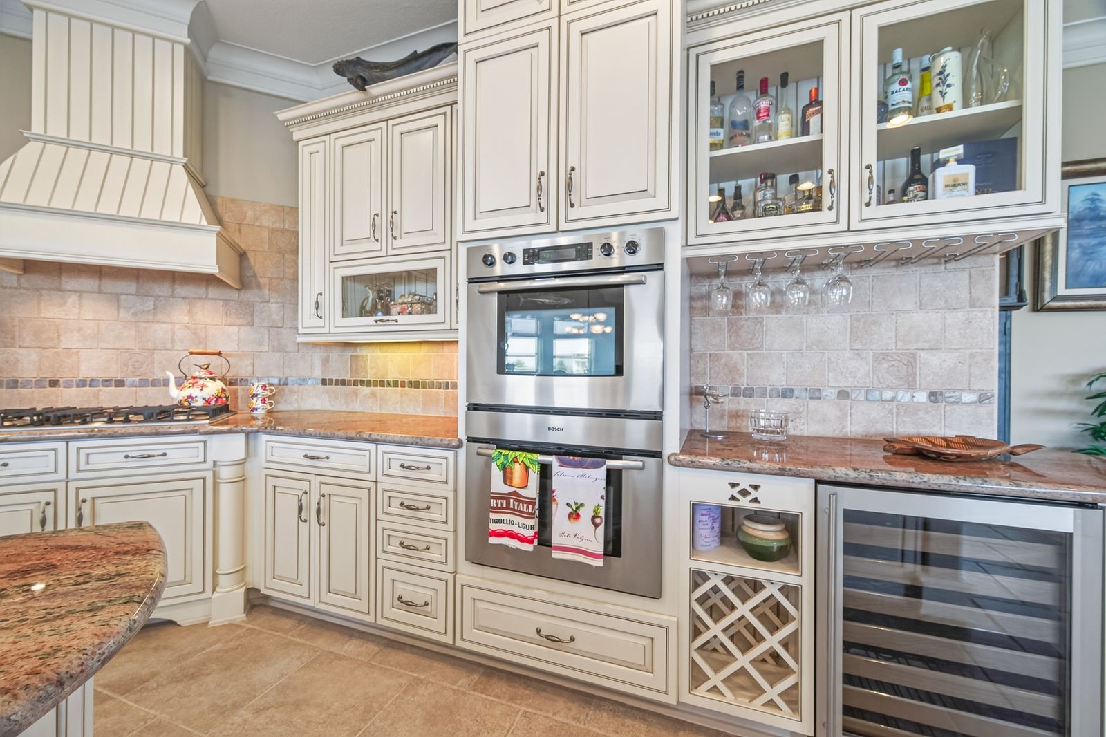 Experience luxury with decorator finishes, ample custom cabinets, and a built-in wine refrigerator for perfect entertaining.