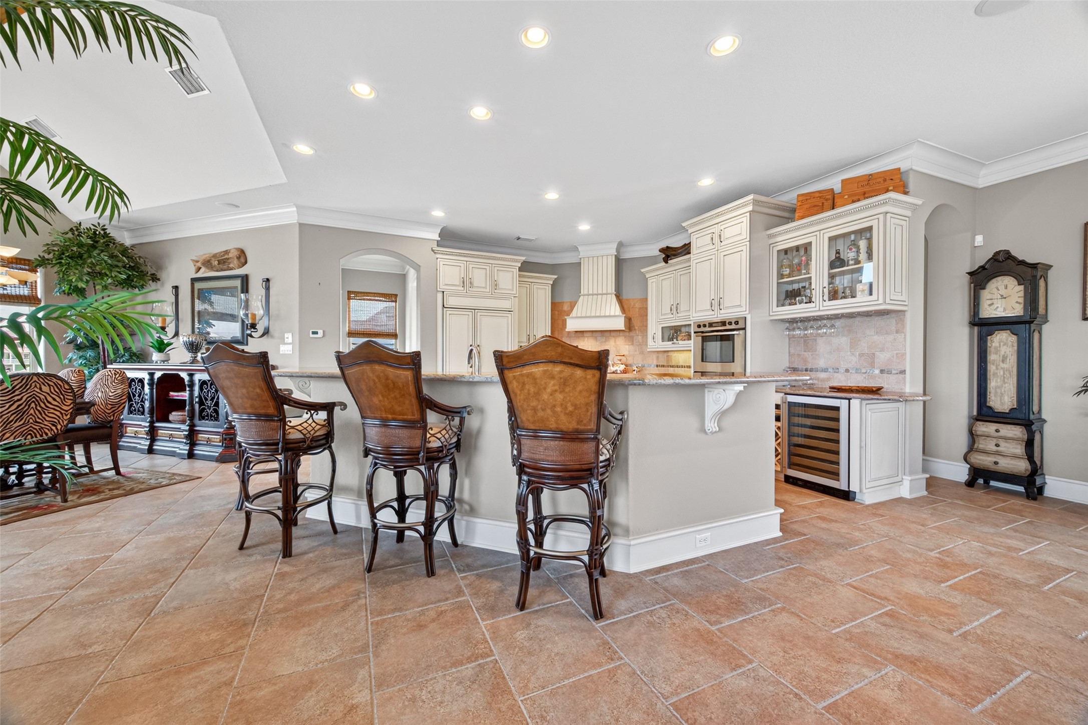 Spacious kitchen with elegant bar seating, custom cabinetry, and built-in appliances, offering a perfect blend of style and functionality.