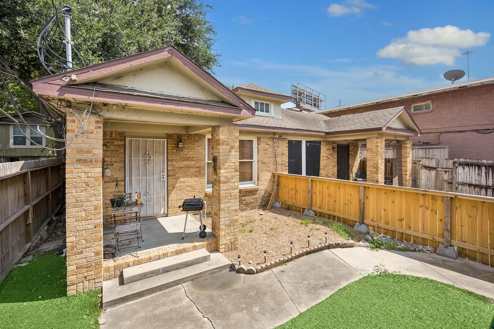 The front duplex features two units, each with a private porch and yard.