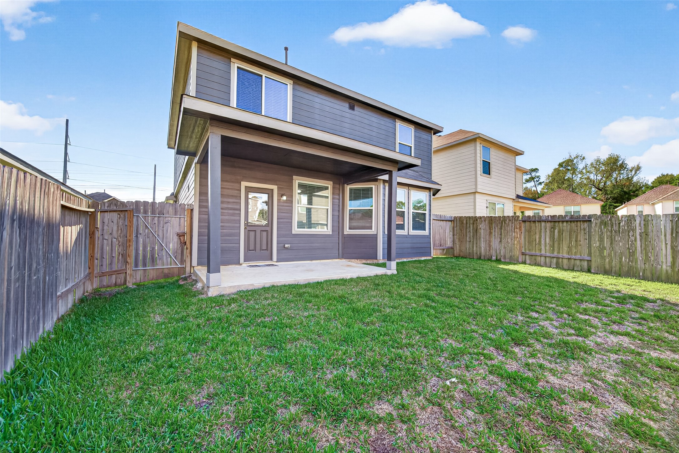 Fenced backyard with a covered patio, perfect for outdoor entertaining and relaxation.