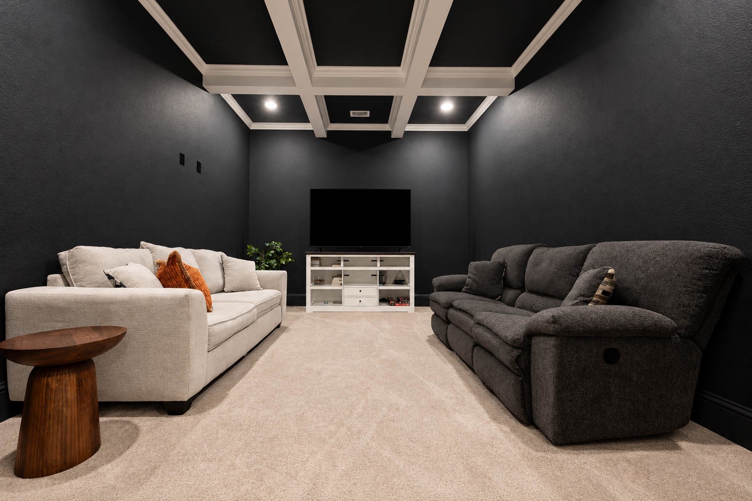 Experience ultimate comfort in this sophisticated home theater, f, a sleek entertainment center, and a stylish coffered ceiling.