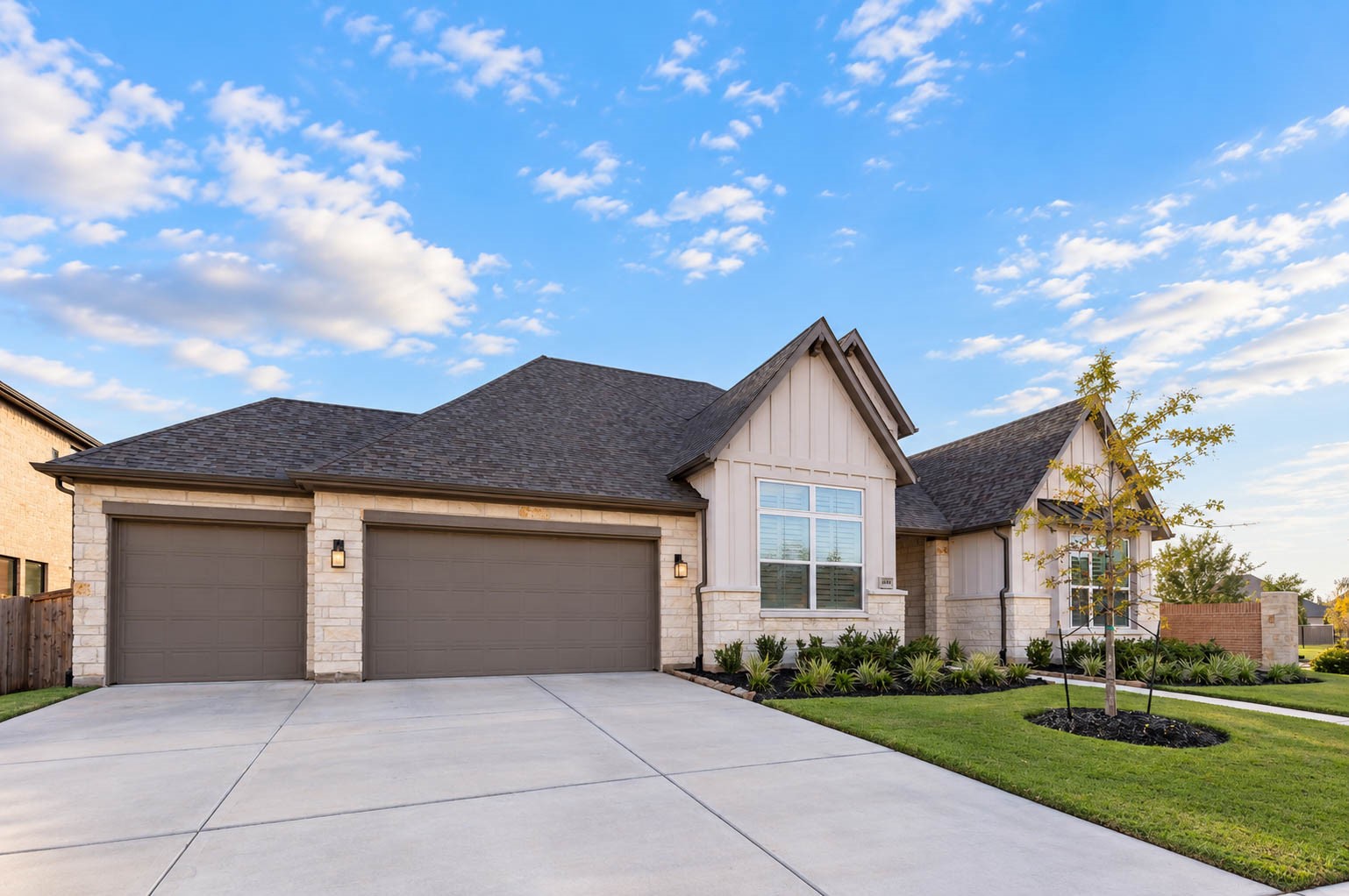 Charming single-story home with a stone and stucco facade, featuring a spacious three-car garage and beautifully landscaped front yard. Charming single-story home with a stone and stucco facade, featuring a spacious three-car garage and beautifully landscaped front yard.